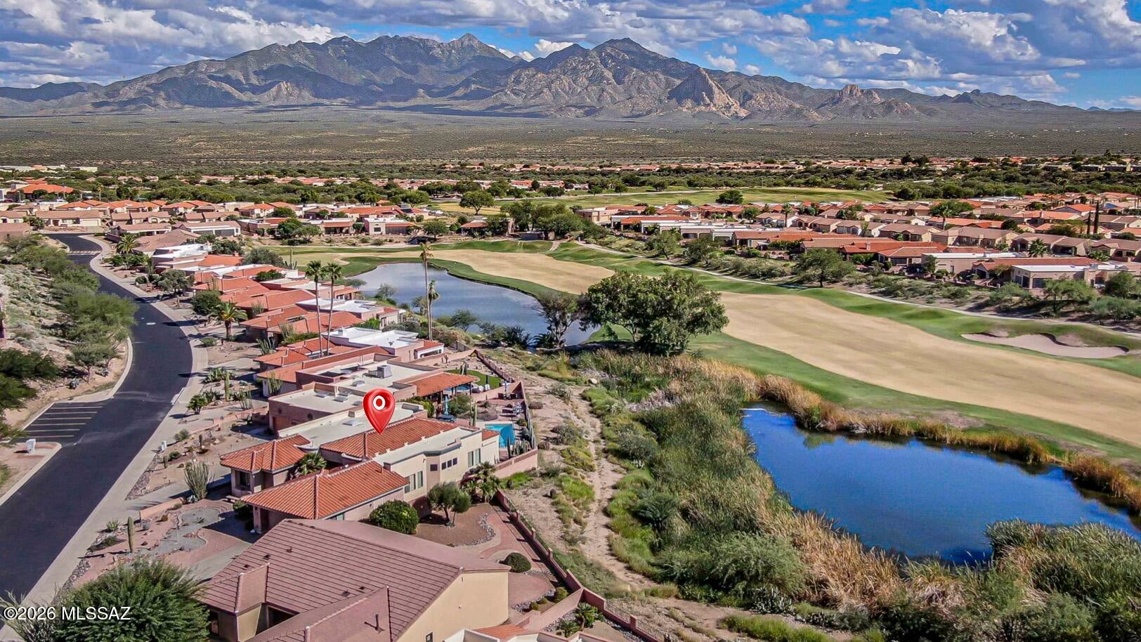 SPECTACULAR GOLF COURSE SETTING, MOUNTAIN VIEWS & PRIVATE POOL! Discover a resort lifestyle in this exceptional 3-bedroom, 2.5-bath home overlooking Signature Hole #13 of the San Ignacio Golf Course. With beautiful mountain and fairway/water views, a private pool and generous living spaces, this is a home designed for entertaining, relaxing, and enjoying the Arizona lifestyle year-round. The spacious formal living and dining area features beautiful wood flooring and three large windows that perfectly frame the fairway greenery, filling the space with natural light and creating a gorgeous backdrop for everyday living and entertaining. The light and bright cooks kitchen is ready to impress with expansive granite countertops, a center island, stainless steel appliances, large built-in refrigerator, induction cooktop, built-in double ovens, and a breakfast bar. It opens beautifully to the inviting family room, creating a comfortable gathering space with easy access to the backyard and pool. A desirable split-bedroom double en-suite floor plan offers privacy and comfort for both owners and guests. The spacious primary suite is a relaxing retreat featuring wood flooring, a bay window, walk-in closet, and large en-suite bath with dual vanities, whirlpool tub, and separate tiled shower. Two additional bedrooms provide plenty of flexibility for overnight guests, a home office, fitness space, or hobby room. The guest suite features wood flooring, bay window, en-suite bathroom with dual sinks and a walk-in shower.  A separate powder room provides extra convenience when entertaining. Step outside and discover what makes this home truly special. The large private backyard feels like your own resort, complete with a pool, multiple sitting areas, and wonderful views of the golf course and surrounding mountains. A covered patio with ceiling fans has access from the primary suite, and powered awnings with Sunbrella fabric along with a rolling shutter provide full shade over the poolside patio at the touch of a button.  Enjoy your morning coffee overlooking the fairway and mountains, spend sunny afternoons by the pool, and unwind in the evening while taking in beautiful Arizona sunsets as the mountains and desert landscape provide a gorgeous backdrop. For bird lovers, the setting offers a wonderful opportunity to enjoy the area's abundant birdlife right from your own backyard. Thoughtful updates and practical features continue throughout the home, including a new tile roof (2023), new gas pool heater and pool filter (2023), new PEX plumbing (2025), new water heater (2025), and a termite warranty, plus plantation shutters throughout. A dedicated laundry room with washer and dryer, utility sink and folding area, plus an expanded garage with built-in storage, utility sink, and room for two vehicles and a golf cart, perfect for taking full advantage of the golf course lifestyle. Conveniently located near San Ignacio Golf Club, additional area golf courses, and Green Valley Recreation centers, this property offers an incredible combination of views, space, privacy, recreation, and indoor-outdoor living. This isn't simply a place to call home, it's the Green Valley lifestyle you've been waiting for"