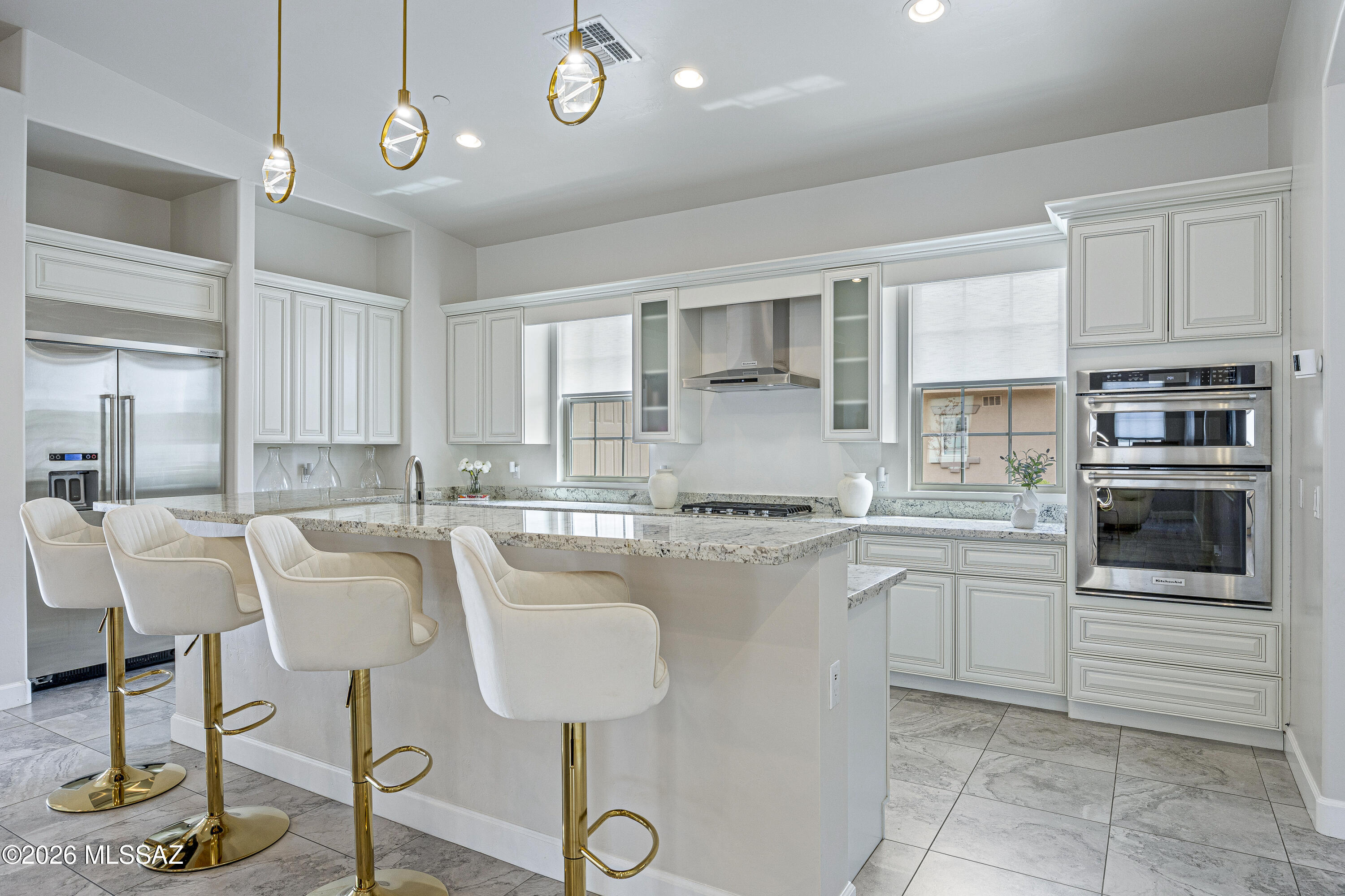 Located within the exclusive gated enclave of Hacienda Del Lago in Rancho Sahuarita, this remarkable semi-custom home offers a rare opportunity to own in one of the community's most private and sought-after neighborhoods, where homes seldom become available. Just steps from the lake, fitness center, tennis courts, water park, and premier amenities, the lifestyle here is as exceptional as the home itself.
Set among only 18 distinctive residences, this one-of-a-kind property is a true standout gem, blending elegance, thoughtful upgrades, and refined comfort throughout. A stunning iron entry door welcomes you in, complemented by brick-accented stairs, soaring ceilings, and a light, bright, and airy ambiance that flows seamlessly from room to room. The grand entrance is enhanced by a partially covered brick driveway, offering both architectural charm and additional parking. Inside, the home features a highly desirable layout, including a private en suite bedroom in addition to the luxurious primary suite. The primary retreat showcases an updated soaking tub, a beautifully tiled glass walk-in shower, and spa-inspired finishes. Every bathroom throughout the home has been upgraded with custom tile work, adding a cohesive and elevated design.
At the heart of the home, the kitchen is a true showstopper, an outstanding centerpiece designed to impress. Crisp white cabinetry, upgraded granite countertops, and premium stainless steel KitchenAid appliances create a space that is both functional and visually stunning, with abundant storage and thoughtful design at every turn. Upgraded lighting throughout the home further enhances its modern, polished feel.
The spacious laundry room mirrors the kitchen's design with matching cabinetry, a utility sink, generous folding space, and a window overlooking the backyard, bringing both beauty and practicality together.
The garage offers a 4-foot extension, ideal for additional storage, hobbies, or accommodating larger vehicles. Outdoors, the backyard is designed for both relaxation and play, featuring low-maintenance artificial turf and an in-ground trampoline, creating the perfect environment for entertaining or everyday enjoyment.
This exceptional property delivers a rare combination of luxury, location, and uniqueness. Welcome home