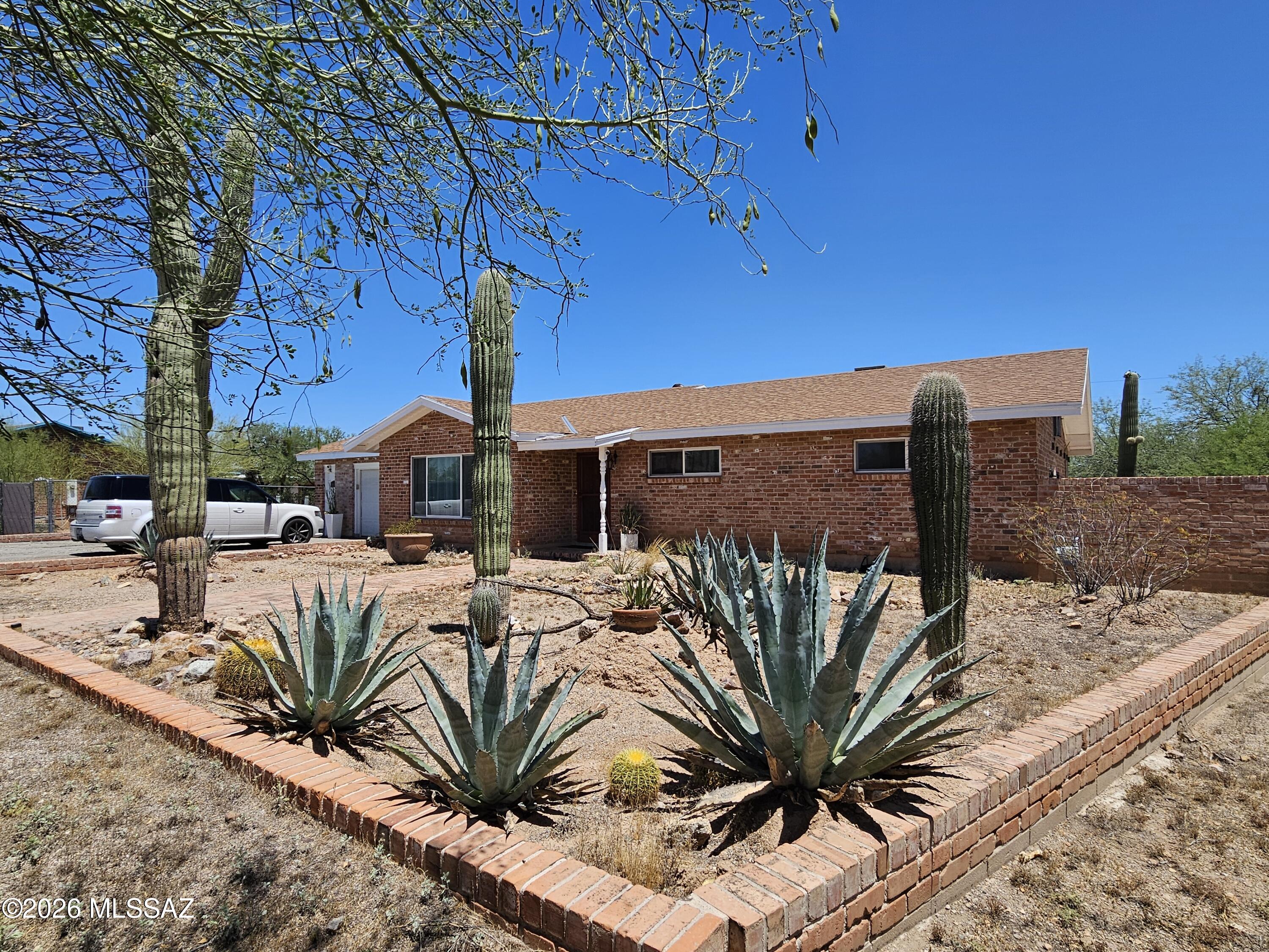 This thoughtfully built westside home offers a rare combination of privacy, location, and potential. Situated on an expansive .35-acre cul-de-sac lot in the desirable Teresa Terrace neighborhood, the property feels peaceful and protected, with open desert beyond the backyard yet remains just 10 minutes from Downtown, the Uof A, and 1-10. Custom built in 1964 and lovingly maintained by only its second owner, the home features enduring craftsmanship, including recycled historic brick sourced from buildings near the UA Medical Center, lending a quiet spirit of Tucson history and character. Energy efficient windows and installation make the home comfortable and move in ready, while its strong bones, subtle mid-century ranch charm, and generous yard offer exciting potential and RV parking!