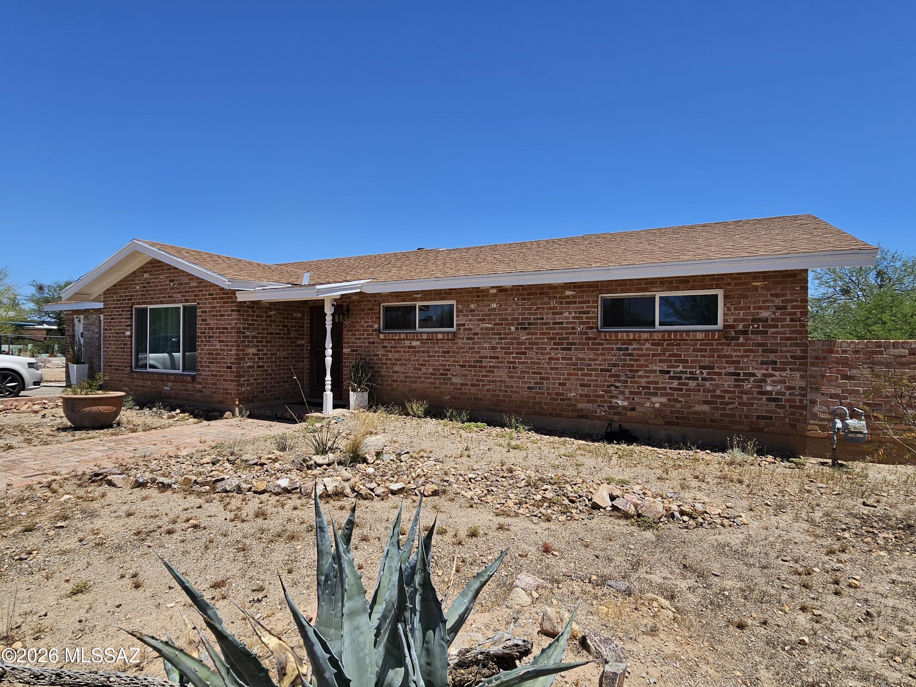 This thoughtfully built westside home offers a rare combination of privacy, location, and potential. Situated on an expansive .35-acre cul-de-sac lot in the desirable Teresa Terrace neighborhood, the property feels peaceful and protected, with open desert beyond the backyard yet remains just 10 minutes from Downtown, the Uof A, and 1-10. Custom built in 1964 and lovingly maintained by only its second owner, the home features enduring craftsmanship, including recycled historic brick sourced from buildings near the UA Medical Center, lending a quiet spirit of Tucson history and character. Energy efficient windows and installation make the home comfortable and move in ready, while its strong bones, subtle mid-century ranch charm, and generous yard offer exciting potential!