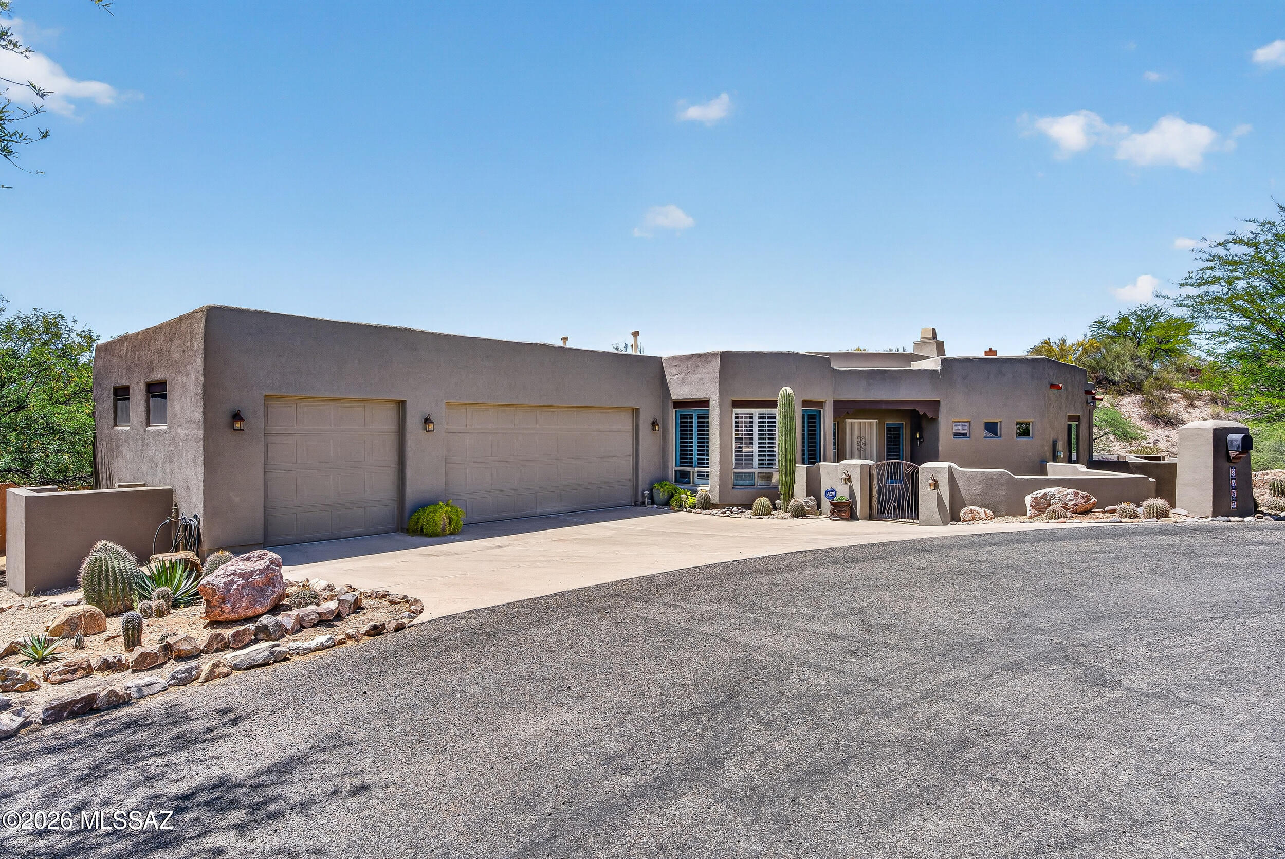Beautiful home located in the heart of the Tanque Verde Valley. Desirable end of cul-de-sac on large lot providing and peaceful and serene setting. Bright and spacious split bedroom floorplan with oversized 3 car garage. Great room concept with gas fireplace and neutral finishes. Spacious kitchen with island/breakfast bar, custom hood, stainless KitchenAide appliances, and walk in pantry. Huge primary suite with cozy fireplace, double vanity, separate shower/tub, and huge walk-in closet. Guest bedrooms include ensuite/Jackn'Jill bath plus 3rd bath near 4th bedroom. North facing back yard and covered flagstone patio overlooking sparkling pool, Natural desert, and Catalina Mountain views! Newer HVAC. Must see!