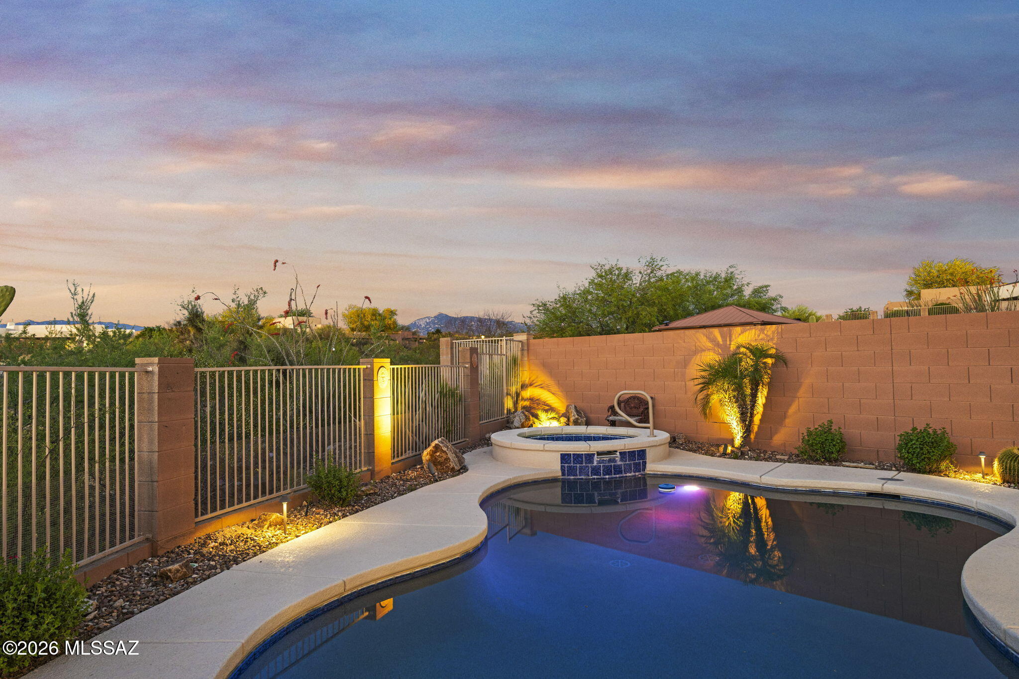 Welcome to Wingview, a gated community at Rancho Del Lago. This home features a heated PebbleTec pool and spa with no rear neighbors, offering privacy along the Rancho Del Lago golf course. Owned solar panels for little to no electric bills and motorized rolling shutters on windows and the back patio for an Arizona Room enclosure.
A Gourmet Kitchen with custom cabinets with pull-out shelves, granite countertops, a gas cooktop, and a wall-mounted oven.
Engineered wood and ceramic tile flooring throughout, custom closet systems, and a surround sound system in the great room, primary bedroom, and back patio. 
Extended-length garage with a car charger, plus a separate third car/golf cart garage with a utility sink. Home includes a fireplace, whole-house water filtration and softener system.