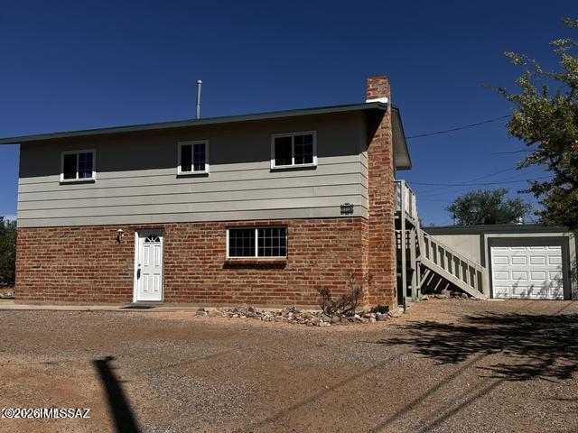 Beautifully remodeled 3-bedroom, 2.5-bath home on a spacious lot with stunning city and San Pedro River views. Features include a 1-car garage with an oversized workshop for flexible use.

The two-story layout offers a large living room, dining area, half bath, and a cozy family room with fireplace on the main level. Brick accent walls and a natural wood ceiling add warmth and character. Upstairs includes all bedrooms and full bathrooms for added privacy.

Updated kitchen and bathrooms make this home truly move-in ready.
