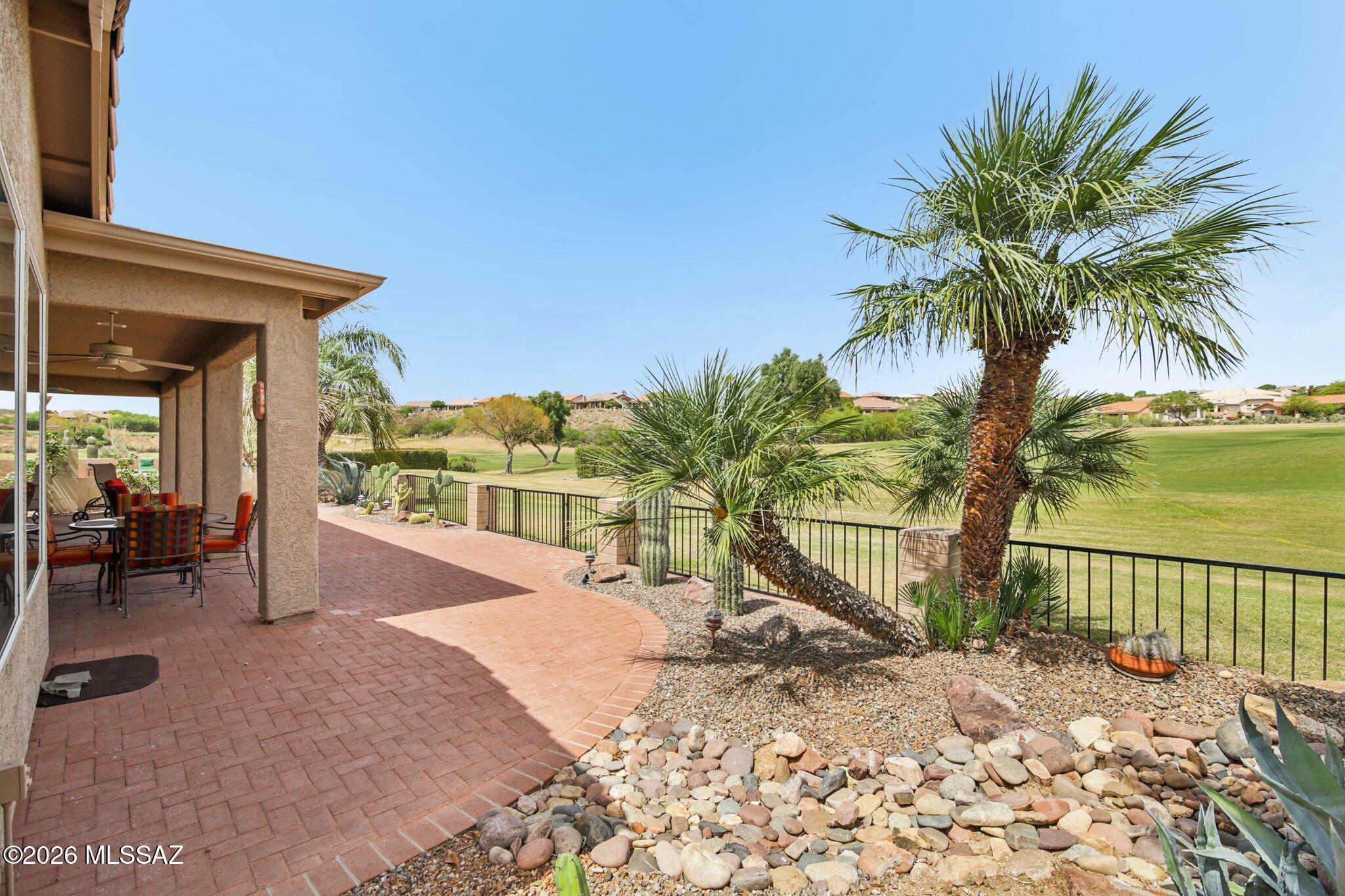 Don't miss this highly upgraded single story Galleria model situated on the 4th Green of the Tucson-Nine golf course with wonderful views.  This move-in ready home boasts a large remodeled chef's kitchen with custom Alder cabinets, granite countertops, tile backsplash and sit up bar.  New wood floors throughout, custom cabinetry, bookshelves, built-in desks in the den, and new arched window in living room.  Large oversized primary suite with sitting area, remodeled primary bath including new vanity and shower with glass door plus storage, updated hall bath and new flooring in bath and laundry. Kitchen overlooks wonderful family room with gorgeous corner style kiva gas fireplace and soft desert colors throughout.  Brick paver courtyard entrance plus wonderful extended covered patio out back with brick pavers, updated landscaping, saguaros and expansive views of the golf course and mountains. It's the perfect spot to enjoy coffee in the mornings and relax in the evenings. Other features include plantation shutters, wood blinds, walk-in pantry, 3 car garage, rolling outdoor shades, and brick paver driveway. You will not be disappointed with this stunning home!