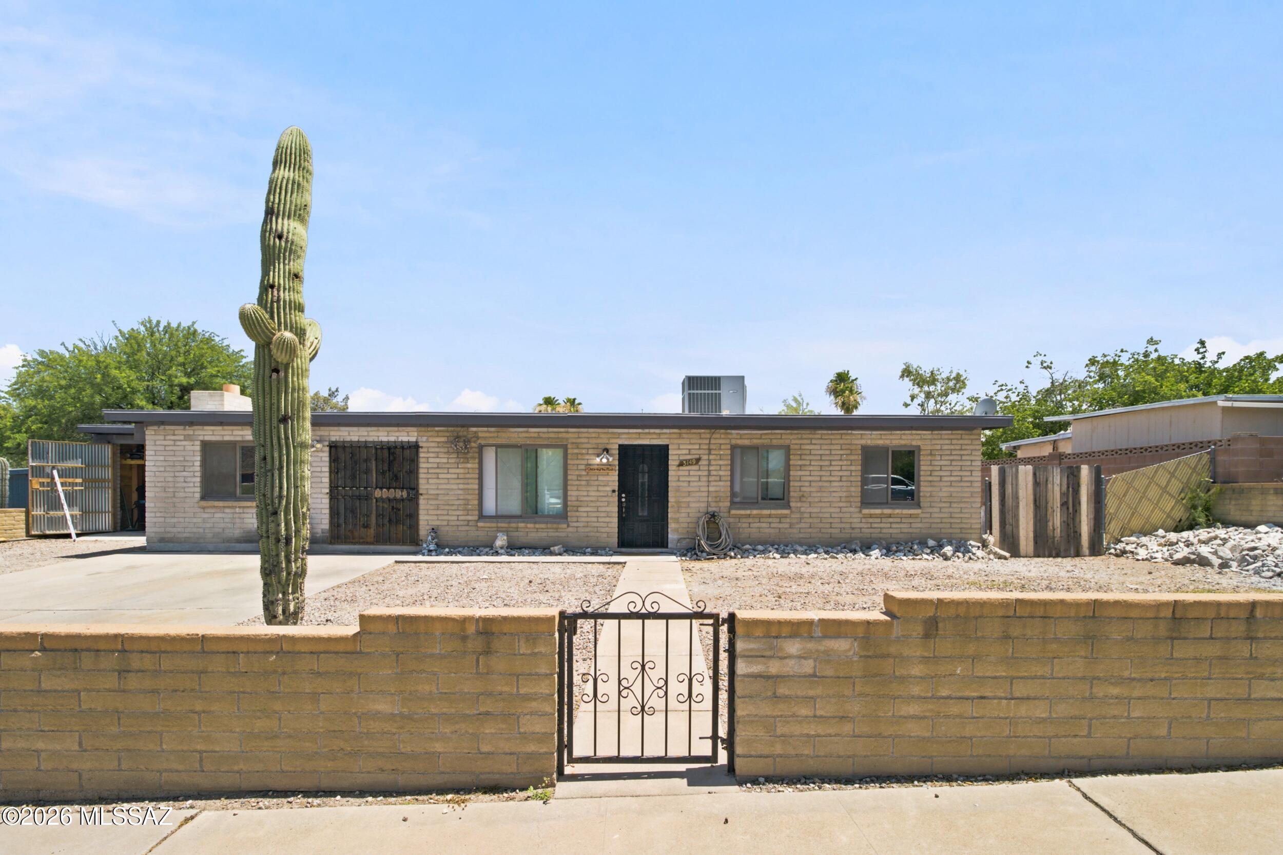 INVESTOR OPPORTUNITY!!!  This Southwest Tucson Property located in a NO HOA Community has Stunning Mountain Views. Beautifully updated 4 beds, 2 baths brick home offering 2,091sq.ft. of open-concept living space. Large lot, ramada & separate completed workshop which can be used as a game room, guest quarters or private office. RV parking, an expansive driveway & garage setup with room for up to 6(six) additional vehicles. NEW IMPROVEMENTS: Custom 42' kitchen cabinets, interior paint(June 2026), remodeled bathroom & permitted Primary Suite added in 2023,NEW roof re-coated (November 2025). SOLD AS IS!!! Buyer to verify all.