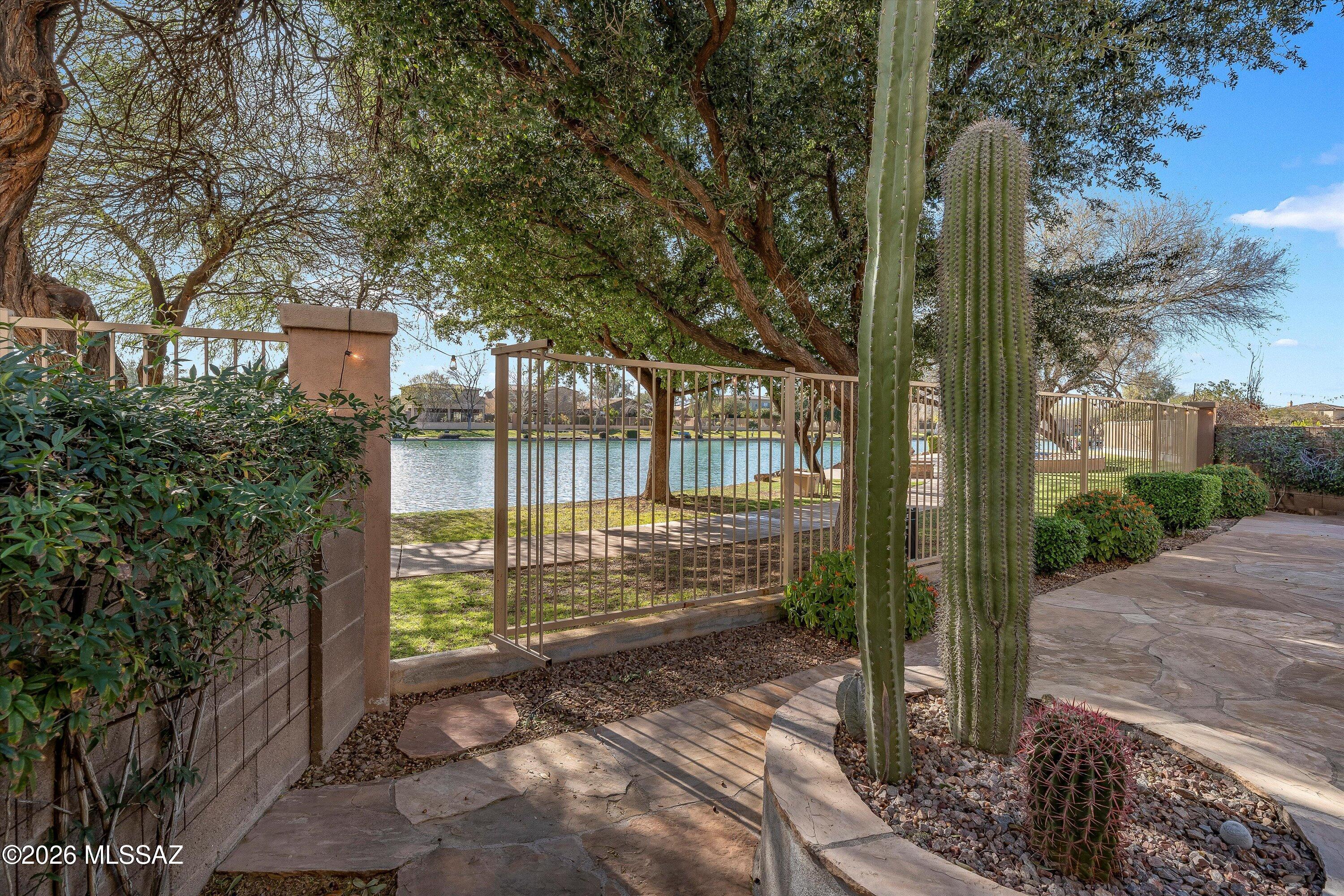 Experience exclusive lakefront living in the gated community of Lago Serreno. This premium lot is one of the few homes with a private gate to the lake! 2 story, 5 bedroom, 4 bath with great curb appeal. Living & dining rooms, family room with gas fireplace, and integrated surround sound with ceiling-mounted speakers. Upgraded kitchen cabinets with crown pull-out drawers & large pantry. Spacious primary suite with lake views, soaking tub, separate shower & huge walk-in closet. Jr primary suite has a full bath and a walk-in closet. Two bedrooms offer balcony access with Catalina Mountain views. BBQ gas stub and low-maintenance backyard with irrigation. Walk over to Club Rancho Sahuarita to enjoy the fitness center & splash pool. Minutes to the freeway, shopping, dining & top schools