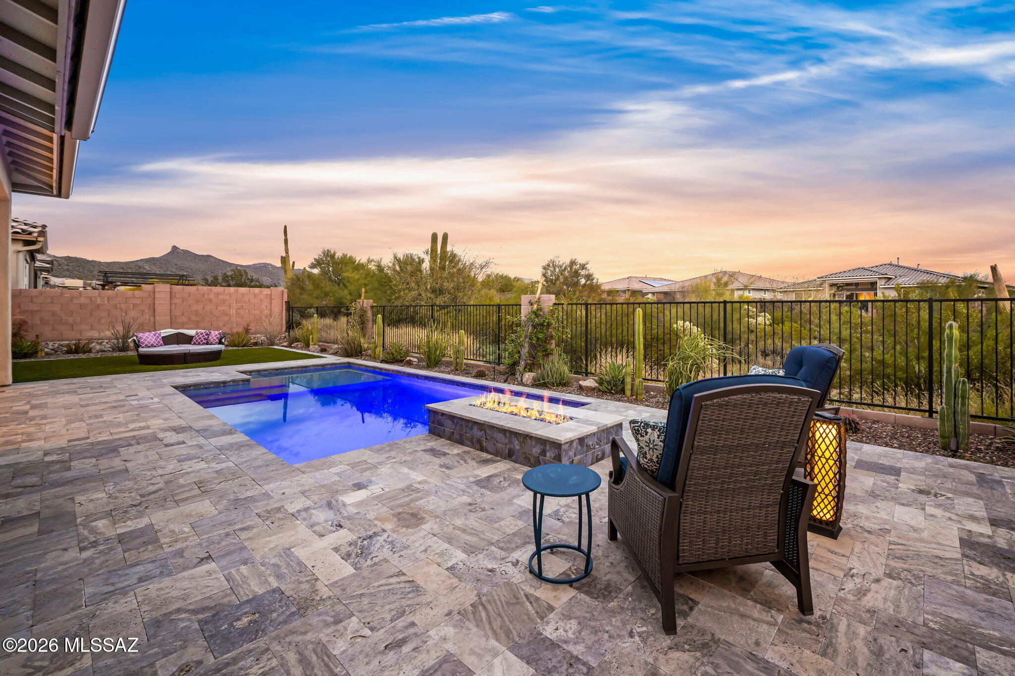 Dove Mountain living awaits at 7753 W Sage Palm Lane. Located in the gated community of Blue Agave, this property offers residents a neighborhood setting close to incredible amenities. Completed in 2022 and upgraded from there, the home feels brand new. A sprawling single story with a split 3-car garage, 2762 square feet, 3 bedrooms, a den, and 2 ½ bathrooms allows for a variety of uses. Many upgrades were included at the time of construction, including a paver drive, stacked stone exterior, oversized stacking sliding door and a gourmet kitchen. Entering through the front door, the home feels bright and connected to the outdoors. High ceilings and light-colored finishes create an airy space. In the well-appointed chef's kitchen, you will find stainless appliances, gorgeous granite counters, a gas cooktop, walk in pantry and modern backsplash. Throughout, the windows have been finished with plantation shutters allowing for different levels of light and privacy. The primary suite is spacious, including a spa-like bath with a soaking tub & walk-in shower, along with a huge walk-in closet.  The guest wing is nicely tucked away and provides access to the 3rd bay garage, which would be an excellent gym, shop or storage space.

Seamlessly flowing from the great room sits the covered patio and outdoor living space. Silver travertine decking has been added for a clean and high-end look. The heated swimming pool includes a lounging shelf, in-floor cleaning, a UV filter, and has been designed with a gas fire pit. Fully finished with professional landscaping, there is a grassy area for lounging and a beautiful assortment of desert plantings with drip irrigation.

A resort-like feel is inherent to this setting. From this home, residents can easily Mountain Park West, which includes a playground, ramada with picnic tables, bathrooms, a dog park, pickleball courts and a large grassy area with views of the Tortolita Mountains. Immediately outside the gate, residents enjoy the Dove Mountain trail, a graded path for walking or running that spans 7 miles.  Just a short dive, you will find The Golf Club at Dove Mountain, The Gallery Sports & Golf Club and The Highlands for golf or amenities galore.  Hikers, trail runners and mountain bikers will revel in the amazing trail systems accessed from The Wild Burro & Tortolita Preserve. Generous bike lanes are enjoyed by cyclists, who can easily access multi-use paved bike paths just outside of Dove Mountain. The recently constructed Dove Mountain C-Stem K-8 school provides bus service, or an easy drop off for those commuting.