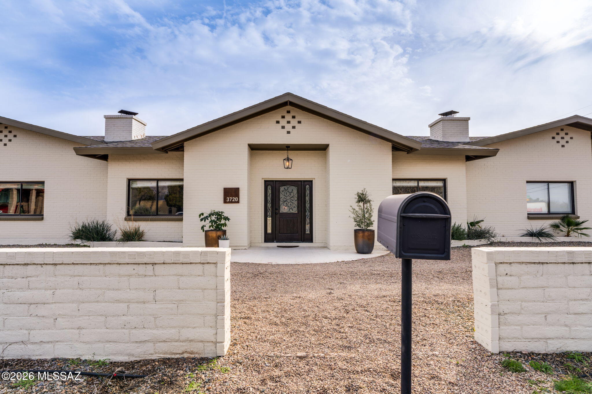 CUL-DE-SAC LOCATION!  ARTIST DREAM!  4,400 SQ FT + Ideal for MULTI-GENERATIONAL families, income-producing guest quarters 2 beds, 1 bath - perfectly adaptable to a buyer's needs. HUGE INCOME OPPORTUNITY - Sellers made over $26k part time renting out 1,100 sq ft guest quarters in 2025.  Main residence includes 3 beds & 2 full baths & split floor plan, centered around a grand family room & soaring ceilings. Kitchen is designed for both function & style, featuring a high-end 36'' gas chef's range, oversized quartz island & seating for six, a mix of solid walnut open shelving & white cabinetry. 2 Car garage/ art studio - add mini split & 400 sq ft. 2 car carport. RV gate, RV elec.  HURRY OVER to this amazin Multi-Gen Property. The painted stucco exterior adds timeless curb appeal. Parking is plentiful with a circular drive, two-car garage, and two-space carport. The lock-out guest quarters offers a private entrance, two bedrooms, one bath, full kitchen with 42" cabinetry, laundry room, and a family room with fireplaceideal for extended family, rental income, or a private wing for parents or children. Altogether, the home features two full kitchens, two living rooms (each with a fireplace), multiple bedrooms and baths and 2 laundry rooms. An oversized entry and common area provides excellent space for entertaining, meetings, or an in-home business. RV-ready with side gate access and electrical hookup, plus no HOA. Conveniently located in a peaceful central neighborhood within walking distance to Tucson Racquet & Fitness Club and the Rillito River Walk, and just a short bike ride to the University of Arizona. This exceptional property is a must-seeschedule your private showing today.