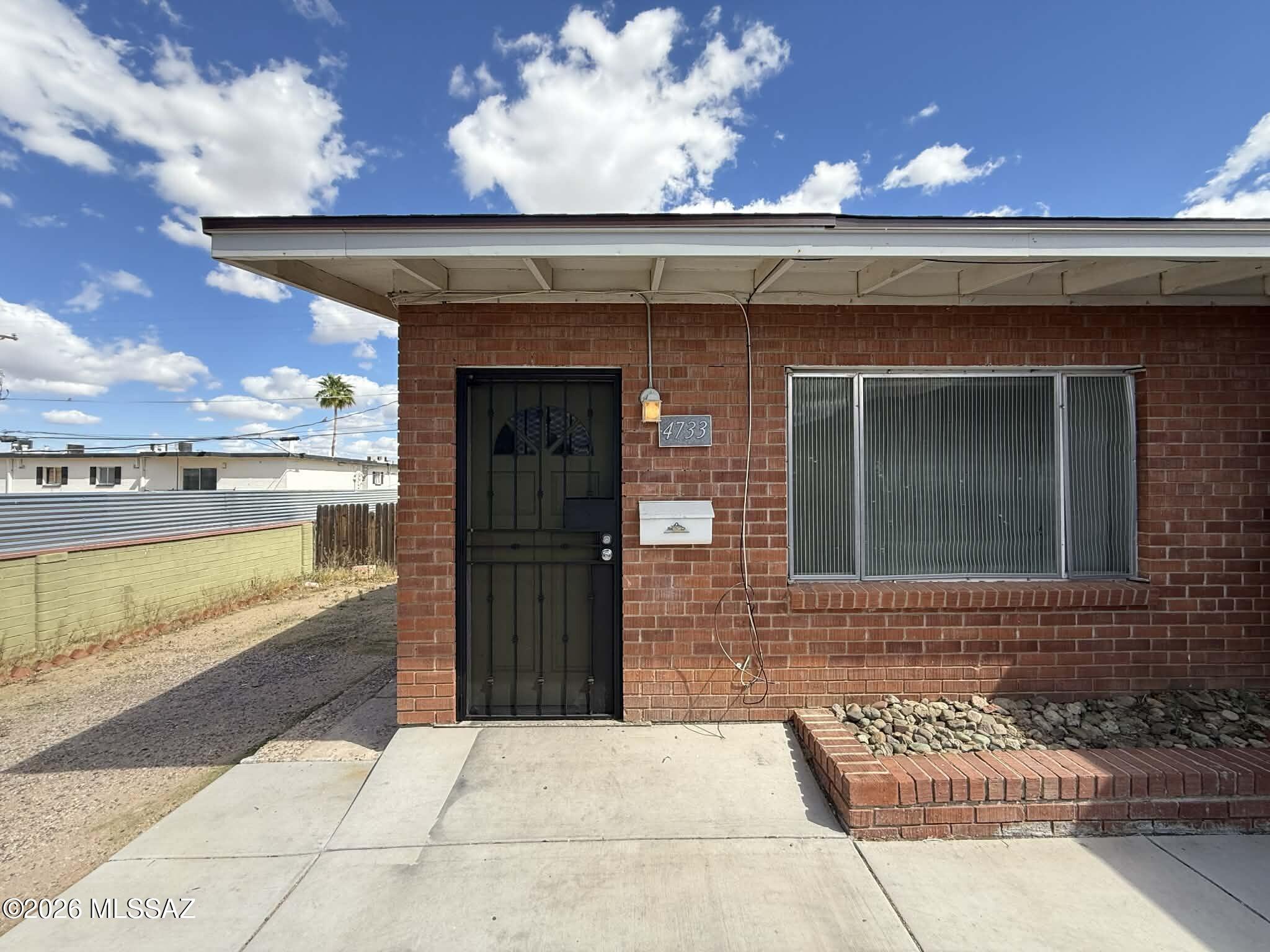 Charming 2 bedroom, 2 bathroom end-unit in a well-maintained tri-plex, offering approximately 800 sq. ft. of comfortable living space in central Tucson. This home features wood vinyl flooring throughout with no carpet, along with fresh interior paint that gives the space a clean, modern feel. The functional layout includes a bright living area and a kitchen equipped with a refrigerator, stove, and oven. Enjoy year-round comfort with air conditioning, ceiling fans, and heating. As an end unit, this home offers added privacy and a large fenced backyard, perfect for outdoor living, pets, or entertaining. Additional features include in-unit washer and dryer, laundry hookups, and a private patio. Conveniently located near shopping, dining, and everyday essentials.