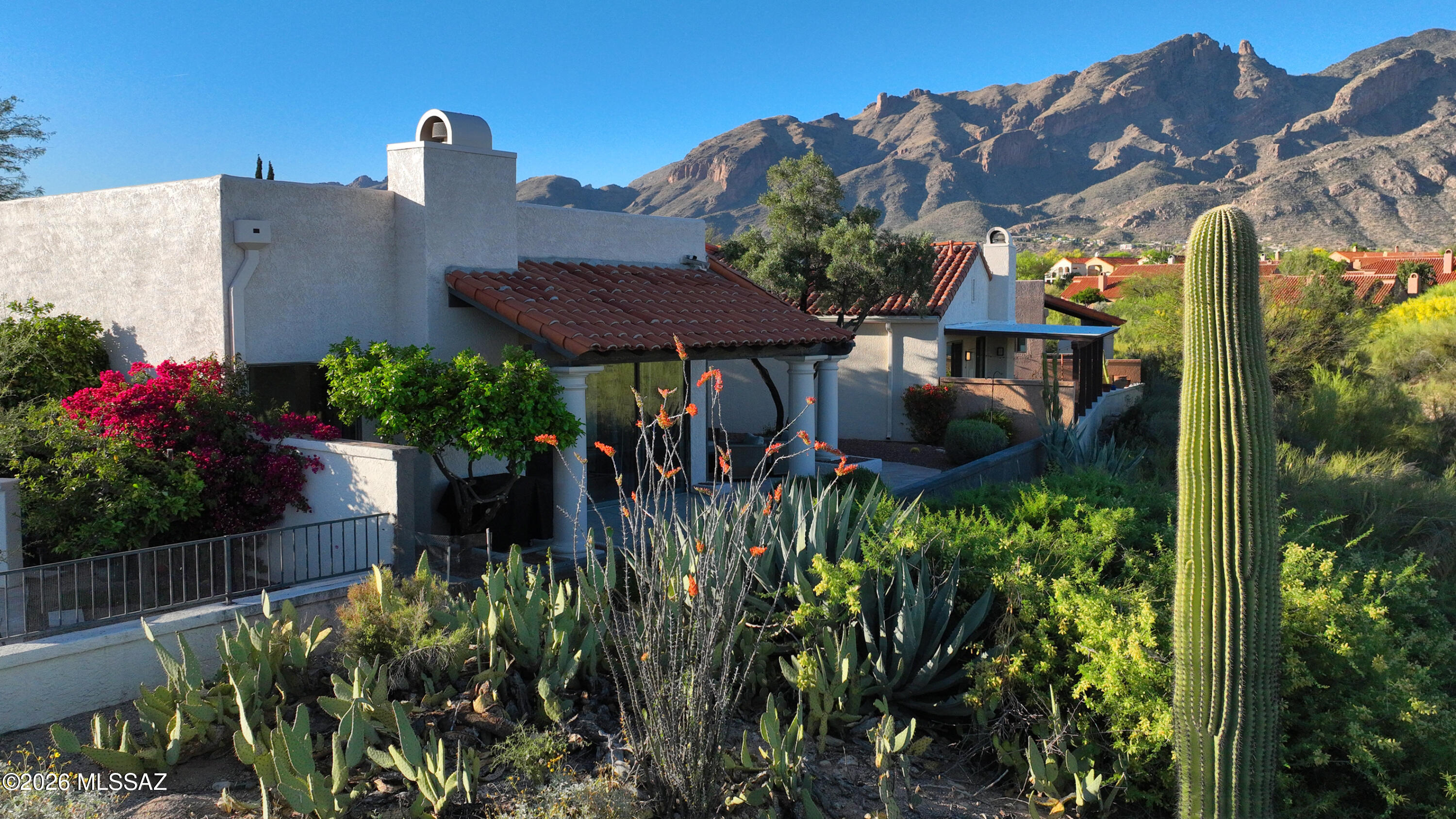 Welcome to luxury living in the highly desirable, gated La Paloma community- Where style, comfort, and breathtaking scenery come together in perfect harmony. This fully renovated home offers an exceptional blend of modern elegance and timeless design, featuring stunning triple views of the mountains, golf course, and sparkling city lights. Natural light pours in through thoughtfully placed skylights creating a bright and inviting atmosphere throughout the home. The spacious primary suite is a true retreat, complete with a spa-inspired bathroom, featuring a walk-in shower, soaking tub, and private patio access perfect for enjoying peaceful mornings or evening sunsets. The open concept living spaces are enhanced by custom built-in bookshelves, a cozy fireplace, and beautiful tile flooring that flows seamlessly throughout. At the heart of the home, the custom kitchen is both stylish and functional, outfitted with a brand new Samsung Bespoke appliance package - ideal for both everyday, living and entertaining. Step outside to enjoy mature, lush landscaping that adds privacy and charm, while perfectly framing the homes incredible views. A two car garage provides convenience and additional storage. Adding even more value, this home has been professionally furnished by an experienced interior designer, with furnishings available under a separate bill of sale, offering a truly turnkey opportunity. Experience refined Desert living in one of Tucson's most sought after communities - this is a home you won't want to miss.