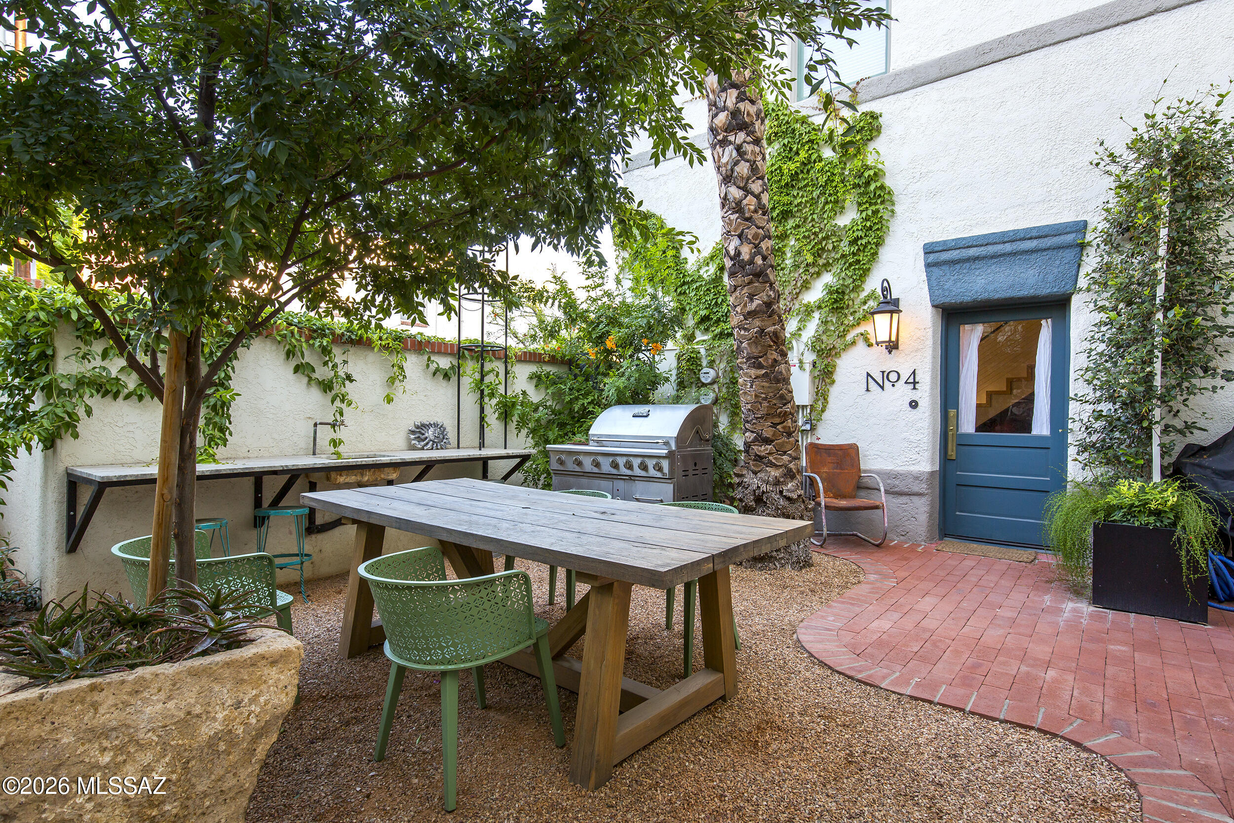 The historic Glenwood Hotel, c.1908, has been thoughtfully reimagined as a boutique condominium building with just six residences. This home is rich in character, craftsmanship, and modern finishes that complement the building's original architectural heritage. Exposed brick creates a striking backdrop for the open kitchen, where custom wood cabinetry and contemporary finishes blend seamlessly with the historic fabric of the building. Hardwood flooring adds warmth and continuity throughout the living spaces, while the spacious primary suite features heated bathroom floors, a custom floating vanity, high-end fixtures, and a beautifully restored clawfoot tub.

Adding another remarkable layer of history, portions of the home showcase walls constructed from volcanic rock quarried from the ba of A-Mountain--an enduring connection to Tucson's early building traditions. An extensive 2024 restoration included the replacement of all mechanical, plumbing, and electrical systems, and high-end finishes, providing modern comfort and peace of mind within one of Tucson's most distinctive historic properties.