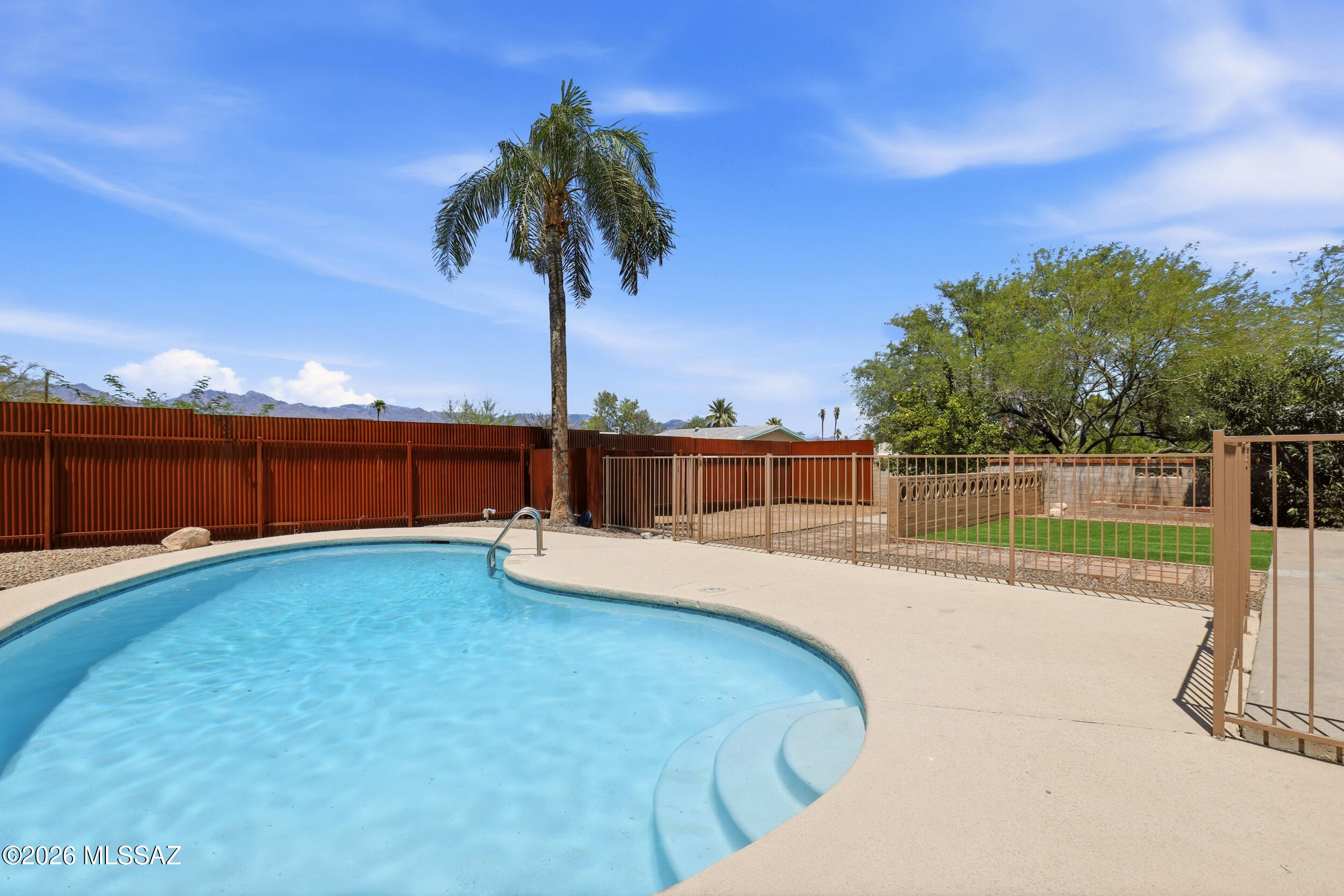Welcome to this charming 4 bed, 3 full bath home with beautiful mountain views. Featuring a desirable split-bedroom floor plan with two primary bedrooms that include an ensuite bathroom and walk in closets. The thoughtfully designed interior offers comfortable living spaces ideal for both everyday living and entertaining. Step outside and enjoy the sparkling pool, expansive front and back yards, and inviting outdoor spaces that create the perfect setting for gatherings. Enjoy peace of mind with numerous recent upgrades that include a NEW roof, Replacement of casement windows, NEW water main drain line, NEW carpet, newer pool equipment & pool resurfacing completed in 2022, fresh interior paint and updated light fixtures throughout. Ideally located near TMC, shopping, dining, and just a short drive to the University of Arizona, this home offers exceptional convenience with no HOA restrictions. Truly move-in ready and turnkey, this beautifully maintained home is ready to welcome its next owners.  Whether you're searching for a primary residence, multigenerational living arrangement, or investment opportunity, this property offers outstanding flexibility and potential. Don't miss the opportunity to make it yours!