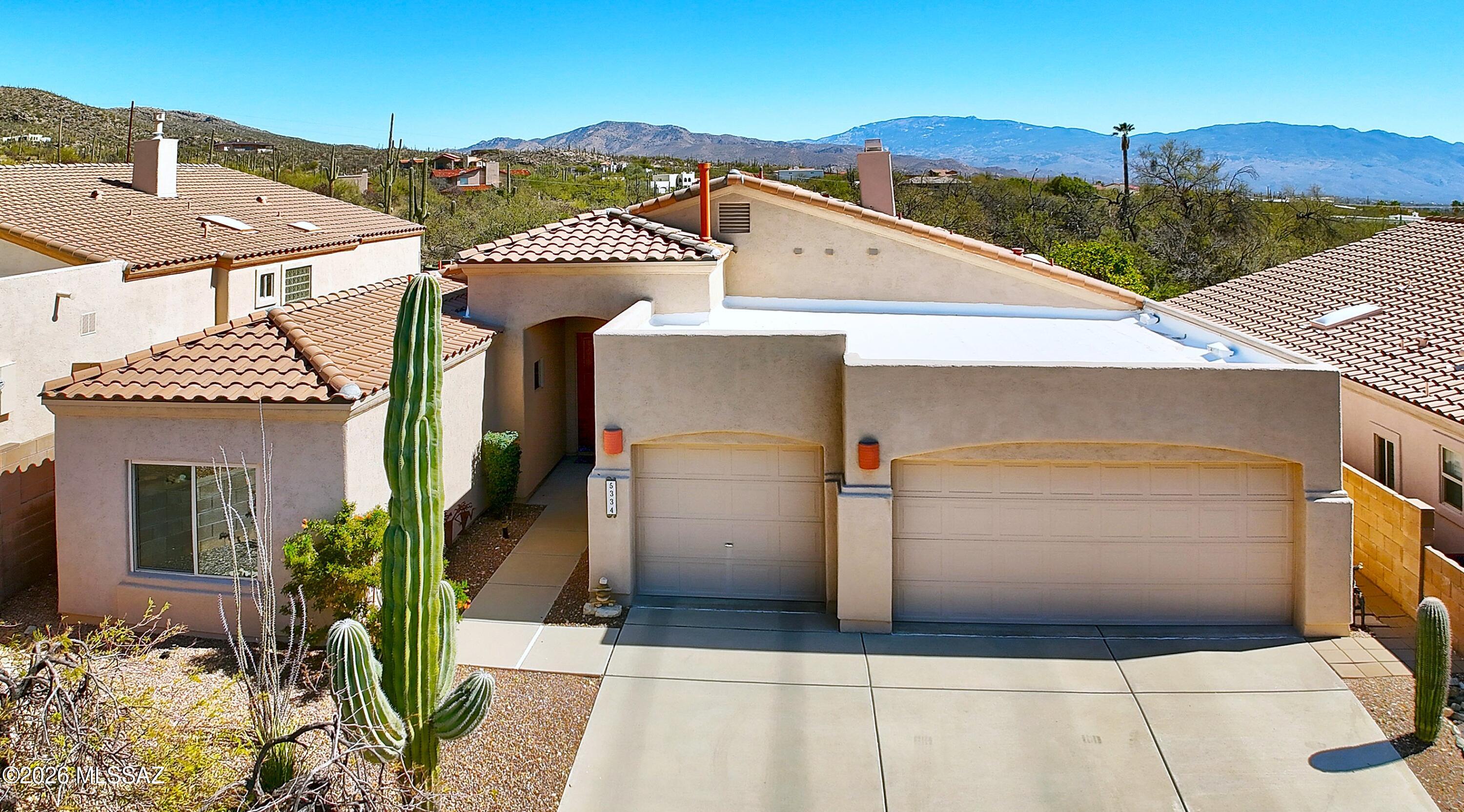 Welcome to his elegant home in the sought after gated golf community of Sabino Springs featuring soaring ceilings, designer tile thruout, 2 primary suites, versatile 3BR/Den and stunning backyard retreat. An impressive 8' entry door opens to the spacious living & dining areas, highlighted by a beautiful fireplace. Sizable kitchen boasts abundant cabinetry, granite counters, SS appliances & gas cooktop that seemlessly connects to the inviting greatroom.  Enjoy the private backyard w/sparkling pool & lg covd patio w/serene mountain views. Primary suite offers dual sinks, quartz counters, soaking tub, w/i shower & 2 closets; 2nd primary has dual sinks, quartz counters as well as w/i shower. Murphy bed in 3rd bdrm is ideal for guests.