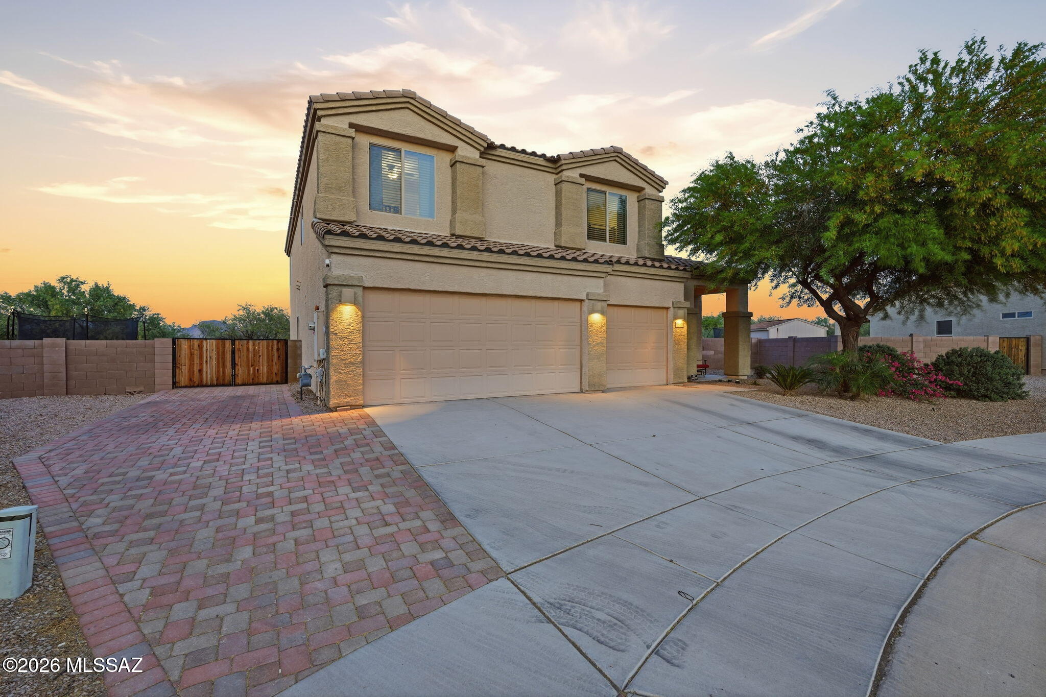 This spacious 4 bed/3 bath home on a huge cul-de-sac lot is the house you've been looking for. This home has a full bedroom & bath downstairs, a 3-car garage, & beautiful mountain views. The 2026 remodeled kitchen features granite countertops & opens to a layout designed for everyday living.  The front side yard has pavers creating a 4th parking space, and the trailer gate gives you easy access to the backyard.  Backing to green space, this large lot offers added privacy and room to enjoy the outdoors. The backyard is a true oasis with drip irrigation, palm trees, & mature fruit trees including peach, apricot, lemon, pomegranate, & tangerine. The home's placement creates shade in the backyard making it useable throughout the day. HOA fees include trash and recycling.  Don't miss this home!