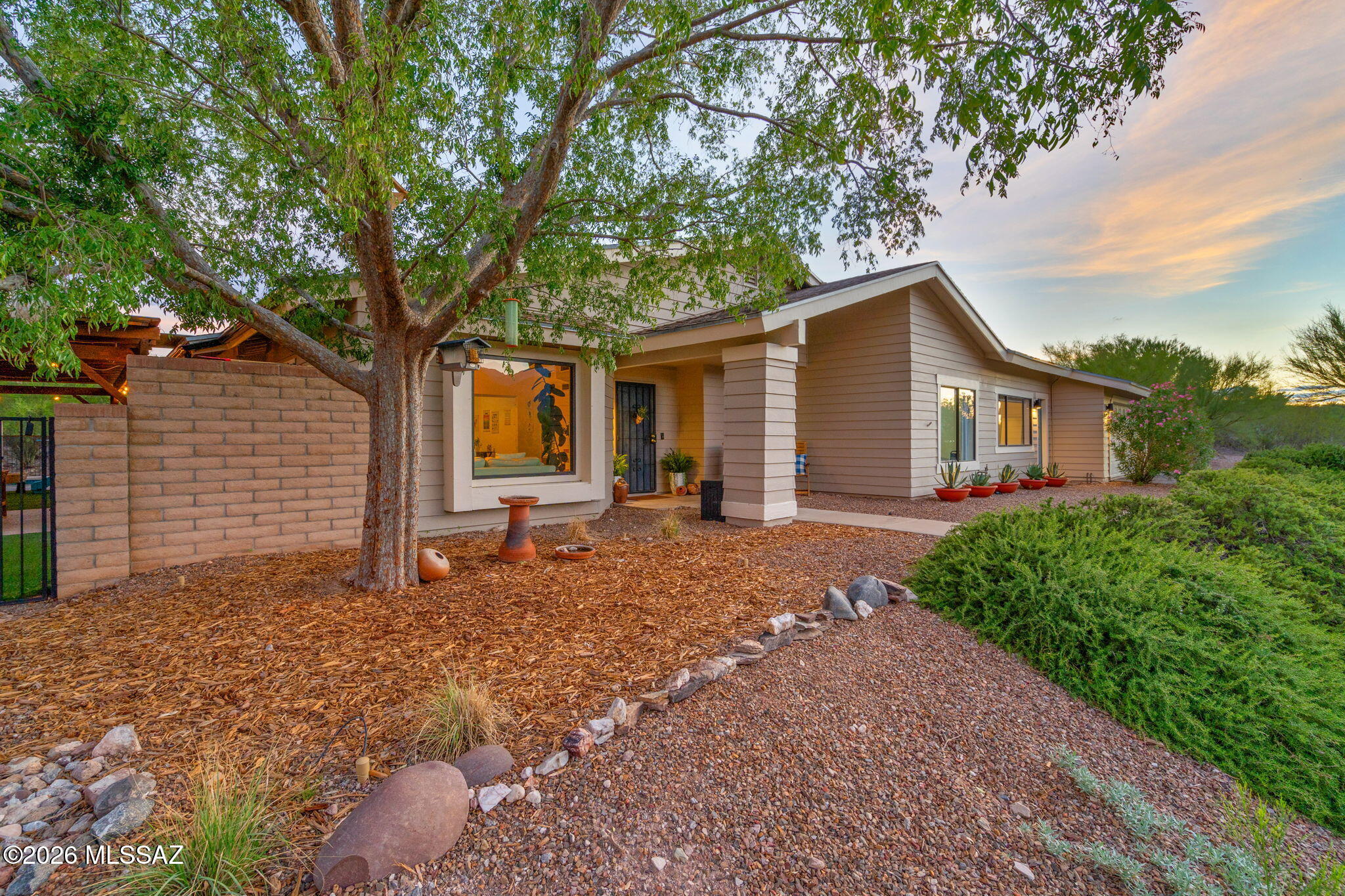 Situated on an elevated .93 acre lot in the highly sought after TV Valley & Tanque Verde School District, this 3 bed + extra room, 2.5 bath home offers abundant natural light, vaulted ceilings, stunning Mountain views, tile throughout, updated modern light fixtures, water softener, RO system in kitchen & blackout cellular shades. The versatile bonus room with a separate entrance offers a new mini split, recessed lighting and half bath, perfect for a home office, studio, guest space or gym. Step outside to your backyard retreat featuring a sparkling newly refinished solar heated Pebble Tec pool, cedar pergola with metal roof, shaded turf & paved seating area, water harvesting, raised garden beds and additional space ready to make your own plus an extended length 2 car garage. Welcome home!