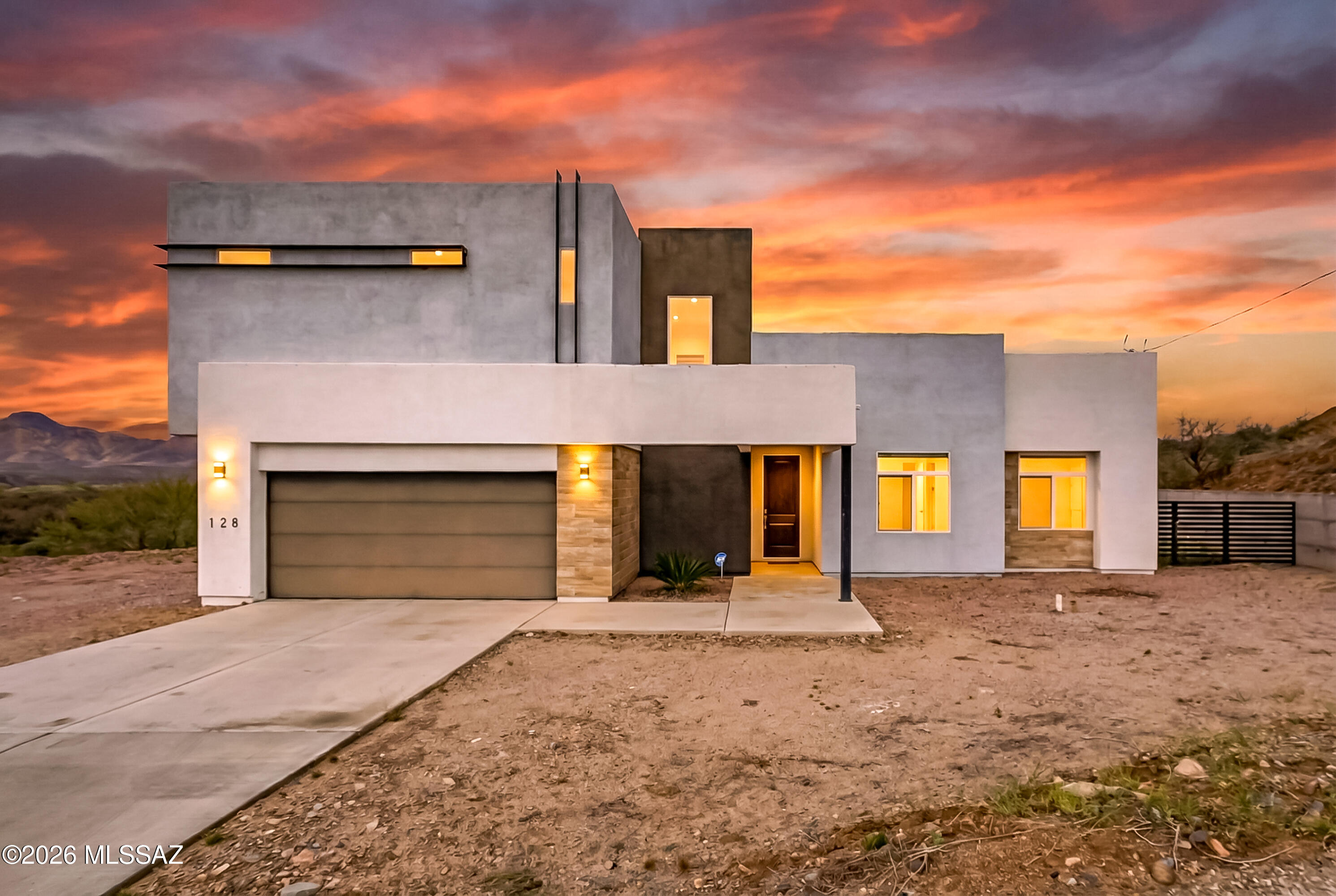 Welcome to this stunning modern two story home, offering 2,046 square feet of thoughtfully designed living space. Upon entering you will notice an open concept floor plan featuring wood looking ceramic tile throughout the main living areas, creating both warmth and durability. The spacious living and dining areas flow seamlessly into a show stopping kitchen, with a large quartz island perfect for entertaining, crisp white cabinetry with soft closing hinges, sleek black finishes for a bold modern contrast, and stainless steel appliances. With 4 generously sized bedrooms and 2 bathrooms, this home offers comfort and functionality for today's lifestyle. The spacious primary suite features a large walk-in closet and an oversized walk-in shower designed for relaxation. Incredible mountain views showcasing unforgettable Arizona sunrises and sunsets can be enjoyed from the extended covered back patio. This home is also conveniently located with easy access to Interstate 19, perfect for the commute to work. This home has it all, come take a look.