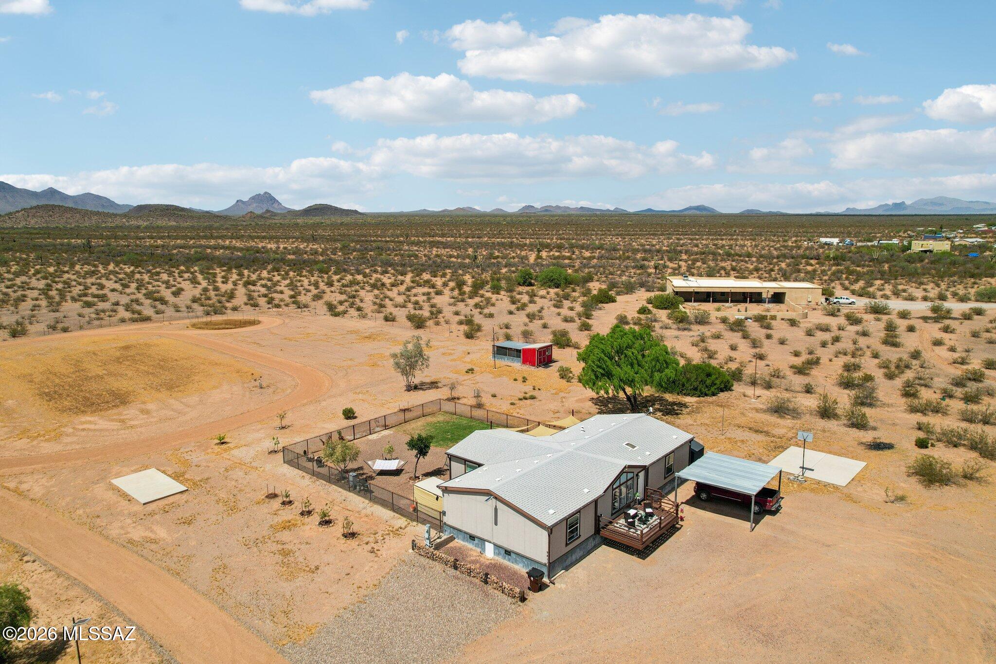 Your Own Private Yellowstone! This stunning 3 bed, 2 bath home is privately tucked away in one of Arizona's most breathtaking farming and ranching communities. This fully fenced and gated 4+ acre horse property boarders the Ironwood  National Monument and the legendary Saguaro National Park ensuring nothing will be built behind you! If you've ever dreamed of wide open skies, rugged mountain silhouettes, and the crunch of desert gravel under your boots, you've just found it! Whether you want a horse barn, a workshop, a livestock operation, off-road vehicle storage, or a simple stunning desert oasis with room to breathe, this is where it begins.  The fully fenced perimeter means your animals are safe and your property is secure from day one. enjoy the chicken coop and corrals all while waking up every morning to panoramic mountain views! Properties like this, the acreage, the setting, the views, the proximity to national monuments, don't come available often, and they don't sit on the market long. Whether you're a horse enthusiast, a rancher, a nature lover, or simply someone ready to trade the noise of the city for the sound of the desert wind. Don't miss out. Schedule your private tour today, then make an offer and make it yours!
