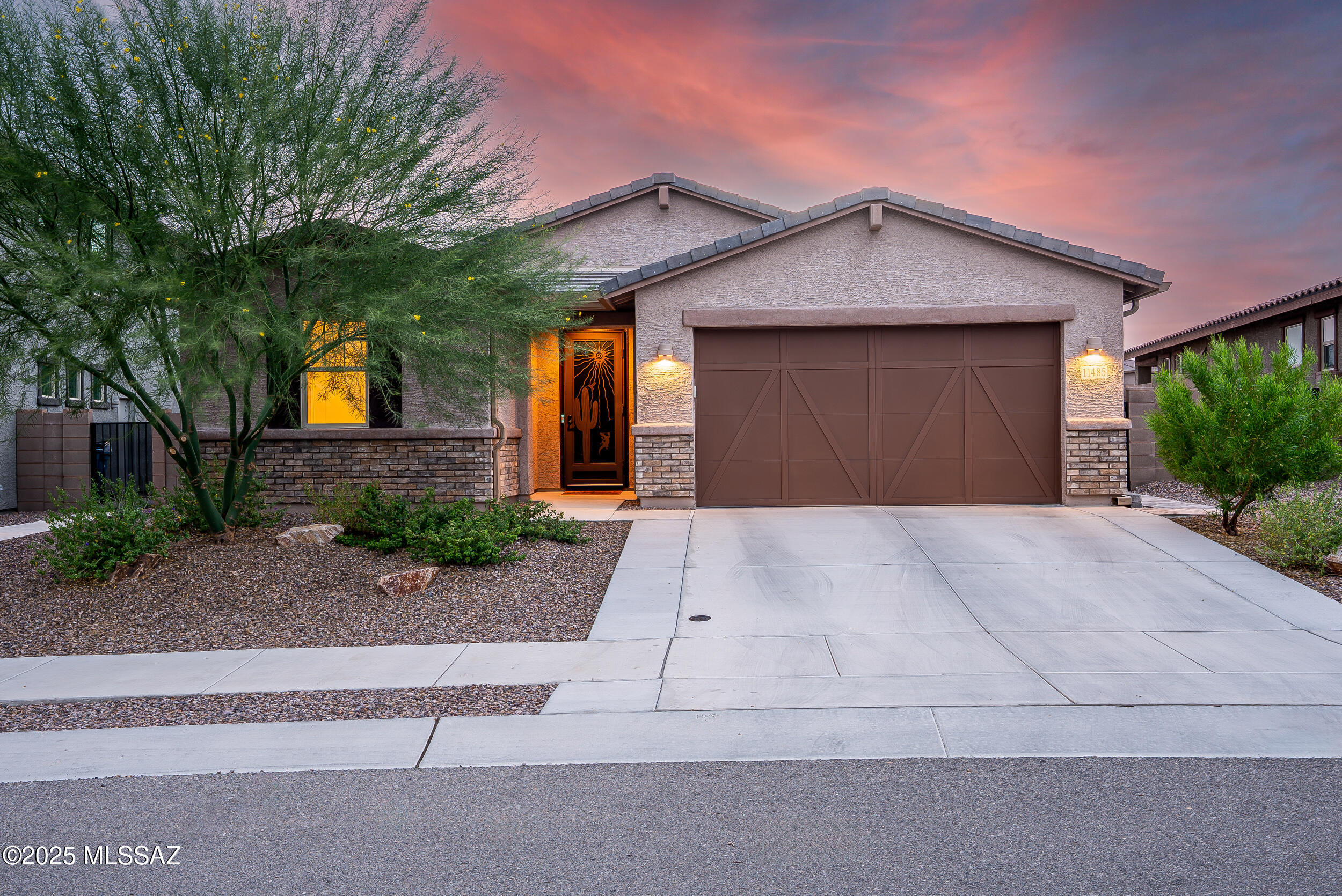 Discover luxurious, modern living in this like-new home located in Oro Valley. Built in 2023, this 3-bedroom, 2-bath residence, plus a den/bonus room, offers an unparalleled blend of style & function. Step inside to an open-concept layout designed for the ultimate lifestyle. The gourmet chef's kitchen is a true showpiece, featuring top-of-the-line SS appliances & a custom tile backsplash, perfect for entertaining or daily culinary creations. The private primary suite is a serene retreat, boasting a luxurious super shower, dual sinks & an exceptionally large walk-in closet. Garage has a 4' extension with hobby space and storage. Guests will enjoy spacious secondary bedrooms & a well-appointed guest bath also featuring dual sinks. The flexible den space is ideal for a home office, gym, or hobby room-or easily convert to 4th bedroom. Outdoor enthusiasts will appreciate the stunning mountain views from the front of the home & the added privacy of backing to a common area. This is the turn-key, contemporary Oro Valley home you've been waiting for!