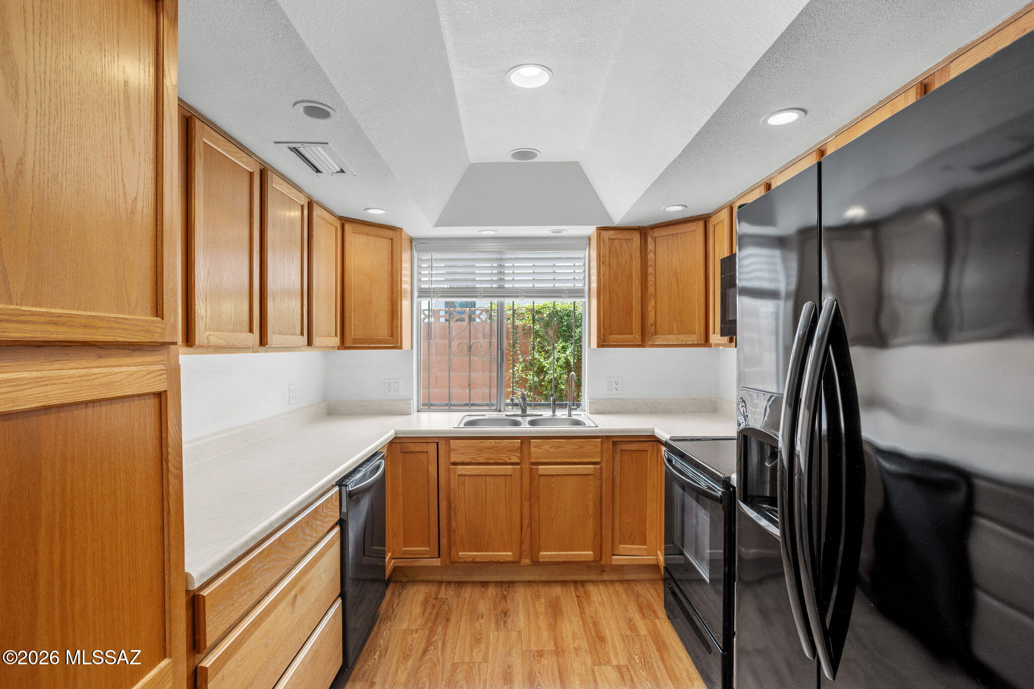 Approximately two miles north of the University of Arizona.
 North Midtown - just off the Campbell Corridor. 
Bonus storage space both front & back Gorgous kitchen, three large bedrooms, two full bathrooms, a half bathroom downstairs, multiple storage closets and a spacious backyard. Located in a private and well manicured community in north central Tucson. Minutes to the Rillito Riverwalk and Mountain Ave. Bike paths. Freshly painted.  Relax in the sparkling community pool Phenominal find in midtown.