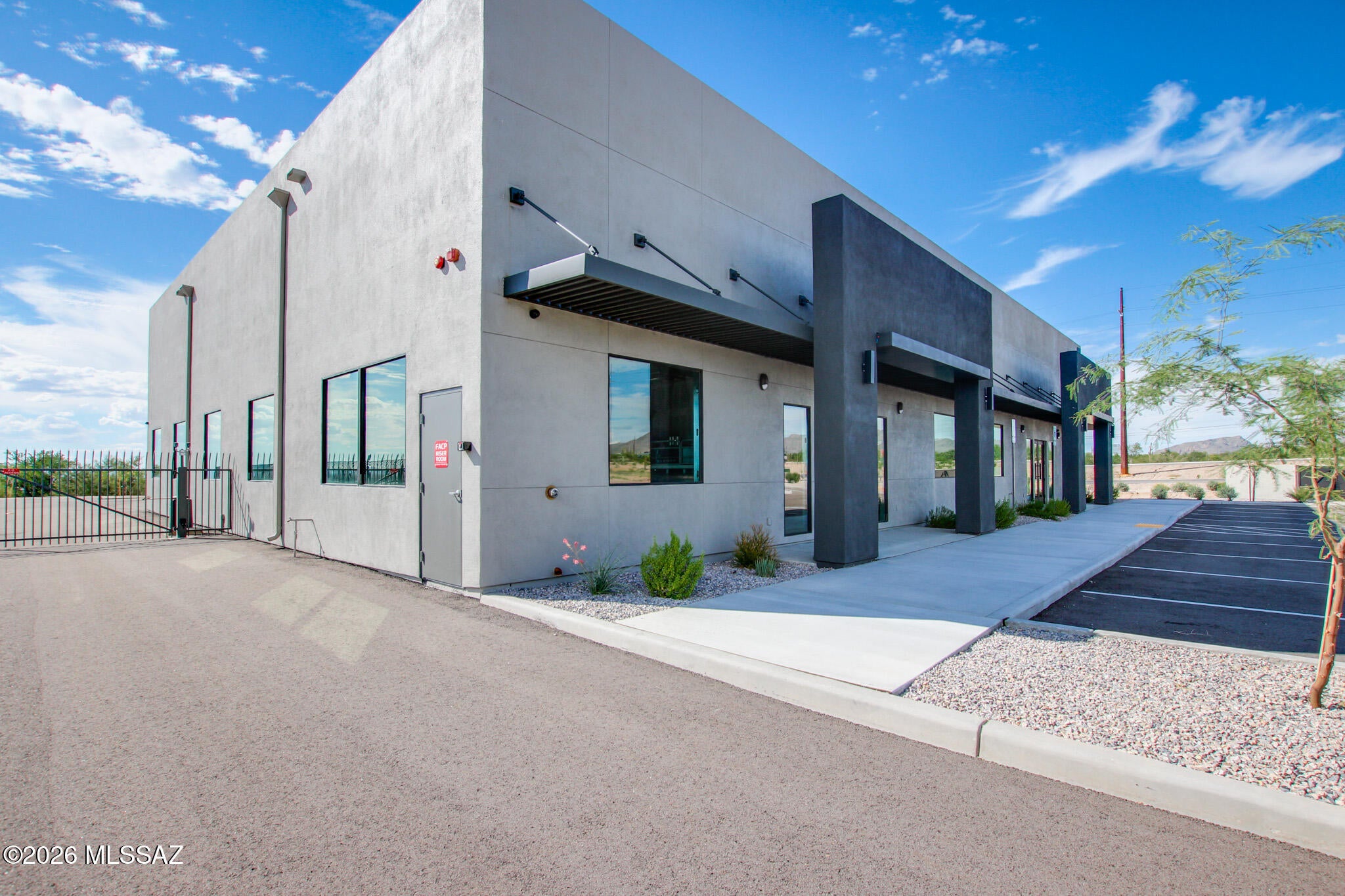 Rare opportunity to lease approx. 3,700 sqft of functional office/warehouse property in Tangerine Business Park. Situated on approximately 1.32 acres, this 7,914 SF freestanding building offers a functional combination of professional office space and warehouse area, making it well suited for an owner-user, investor, or growing business. The office portion features a polished layout with private offices, conference room, reception area, break room, restrooms, and storage, while the warehouse provides four grade-level overhead doors and flexible industrial space. The property also offers paved private parking, attractive desert landscaping, and convenient access to Tangerine Road and I-10. The office and warehouse spaces are also being marketed