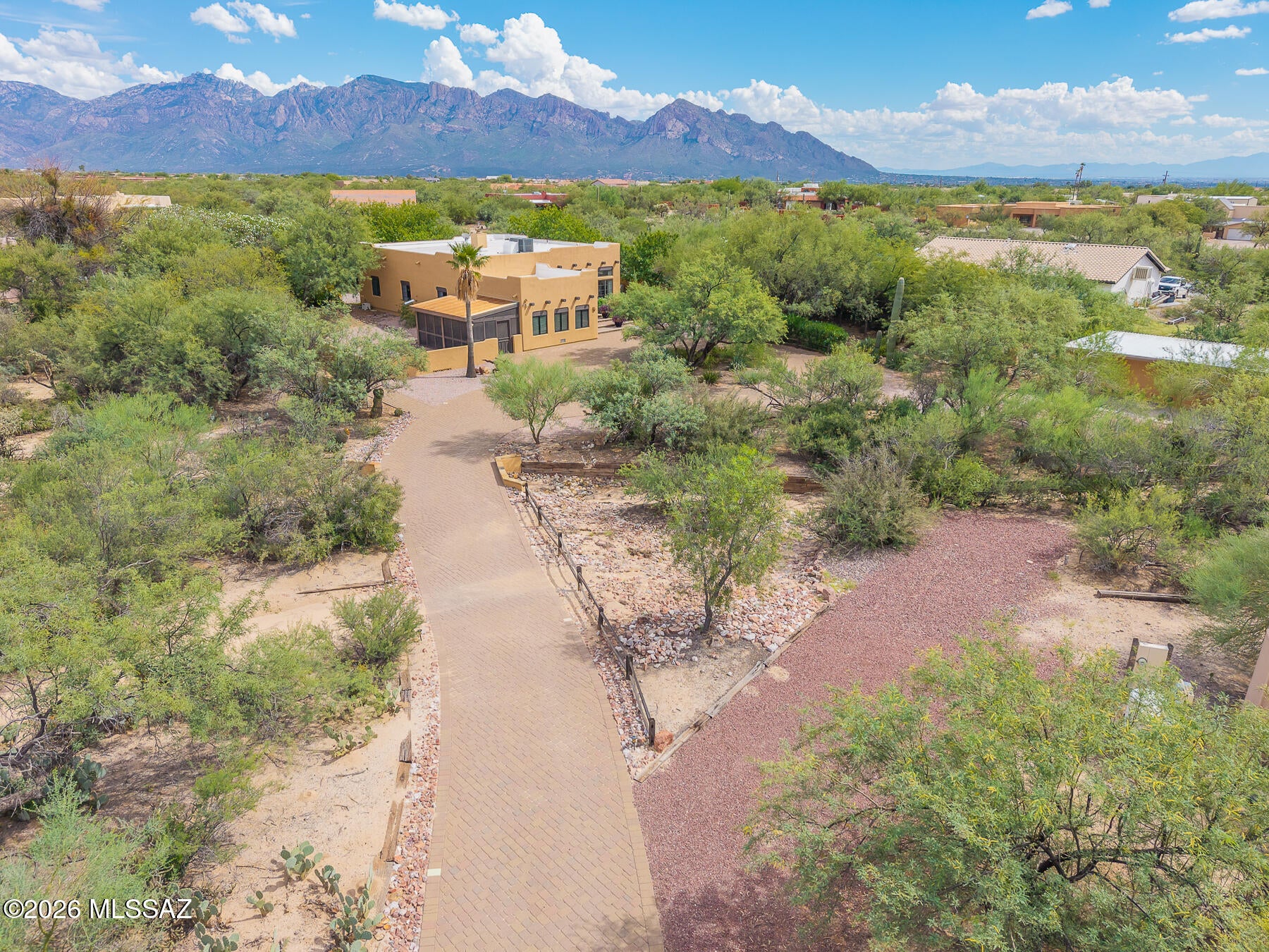 Embrace rare desert privacy and stunning mountain views with this sprawling Southwestern residence that has been totally renovated and has NO HOA! Delivering an impressive 3BD/2BA+Casita+3 Car Garage+Pool/Spa+Bonus Room+RV electric hookup+New HVAC (2,544 sqft), this home balances beautiful Southwestern architecture with day-to-day modern comfort. Nestled on an expansive full one-acre lot, the property provides an abundance of breathing room, natural open space, and privacy seldom found in dense standard subdivisions. Pass through the entrance to discover a light-filled open great room enhanced by towering, beamed ceilings, fantastic southwestern tile floors, and a cozy fireplace. Designed for seamless convenience and entertainment, the floor plan connects the main living and dining areas effortlessly to the culinary core. The generous kitchen features extensive storage cabinetry, leathered granite countertops, and updates you will need to see to believe. The home's floorplan accommodates three spacious bedrooms and two full bathrooms, including a private primary retreat complete with generous walk-in closet space and en-suite bathroom. The indoor living spaces transition smoothly outdoors onto a covered rear patio with fantastic views. Bound by pristine native desert trees, cacti, and mountain backdrops, the sprawling acreage serves as a quiet sanctuary for outdoor dining, poolside relaxation, and watching Southern Arizona's notorious sunrises and sunsets. Perfectly positioned right on the edge of Oro Valley, you enjoy a tranquil, lower-density desert lifestyle that remains just minutes from regional retail hubs and grocery centers.