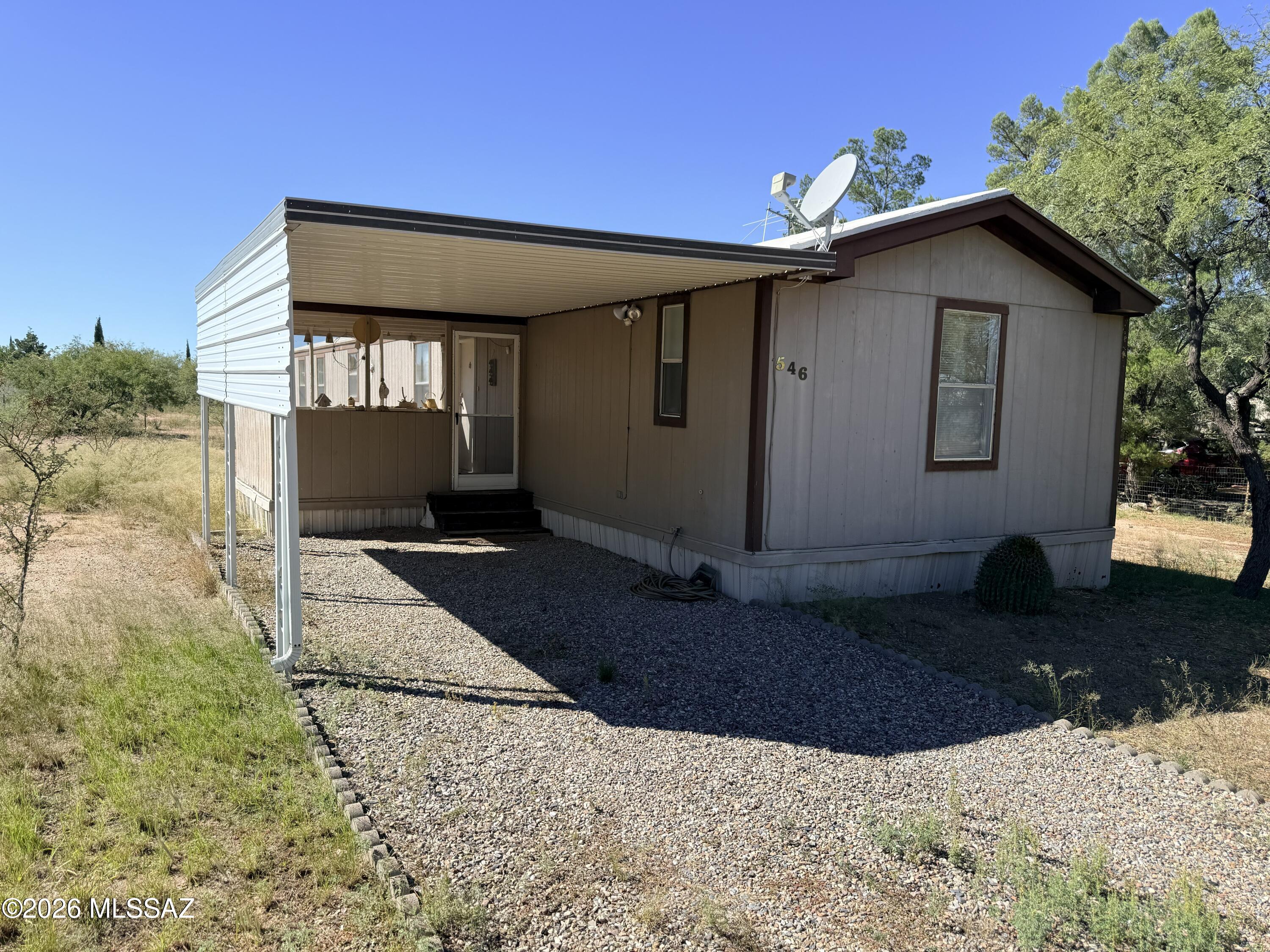 AFFORDABLE OPPORTUNITY WITH OWNED LAND IN BENSON! Looking for an inexpensive home without the added expense of lot rent? This 3-bedroom, 2-bathroom home features a desirable split floor plan and sits on its own 0.19-acre parcel. A great opportunity for homeowners, investors, or buyers looking for a budget-friendly property with potential. With some TLC and personal touches, this home could make a great primary residence, rental investment, or winter getaway. Enjoy the freedom and benefits of owning the land beneath your home at an affordable price. Bring your vision and explore the possibilities! Property is being sold AS-IS.
