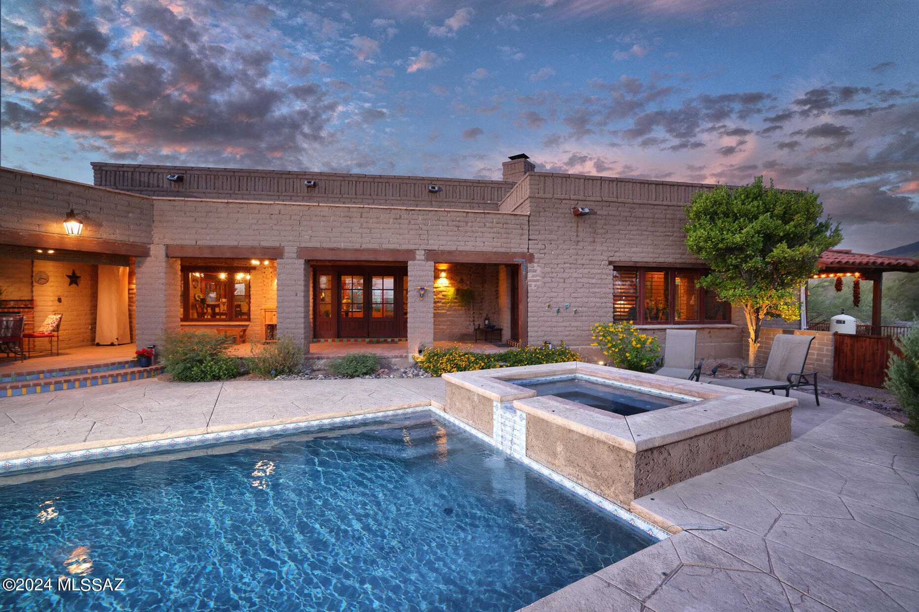 Welcome to Hacienda Puerta de Madera, a sprawling single story mud adobe Hacienda. This one-of-a-kind home is constructed from traditional sun-dried mud adobe bricks which not only is charming but provides thermal insulation. Sitting high on 3.31 acres with 5 bedrooms, 4 full baths, and 2 half baths, including a versatile gym room and a storage room converted into an office/craft space. One bedroom and bath is a separate guest suite with its own entrance. High ceilings, large windows and natural light highlight the unique adobe bricks. The gorgeous kitchen is the interior main attraction while outdoor living awaits with fully equipped BBQ area, pool, spa and outdoor dining. 4.5 car garage, fully owned solar, RV hook-up, roof top deck are just a few of the incredible features of this home.