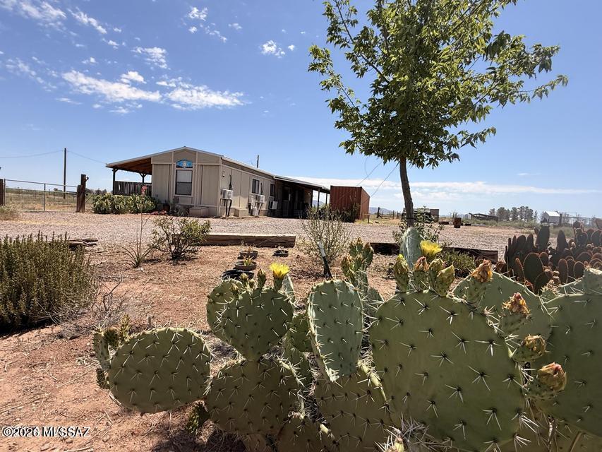 Nestled on 5 acres of peaceful country property, this 3-bedroom, 2-bath single-wide manufactured home offers plenty of room
to enjoy rural living. The property features a chicken coop, goat shed, established garden area, and a spacious covered deck with an attached greenhouse space--perfect for homesteading, gardening, or simply enjoying the outdoors. Water storage tanks and conex container included. Inside, you'll find newer laminate flooring throughout and mini splits. Home has a recently installed metal roof with gutters(2 years), cement siding providing added durability and value. The acreage offers endless possibilities for animals, gardening, recreation, or future improvements. The well is currently producing limited water and may require repair or replacement. Property sold as is This is a great opportunity for a buyer looking for affordable acreage and willing to make improvements to create their ideal country retreat.