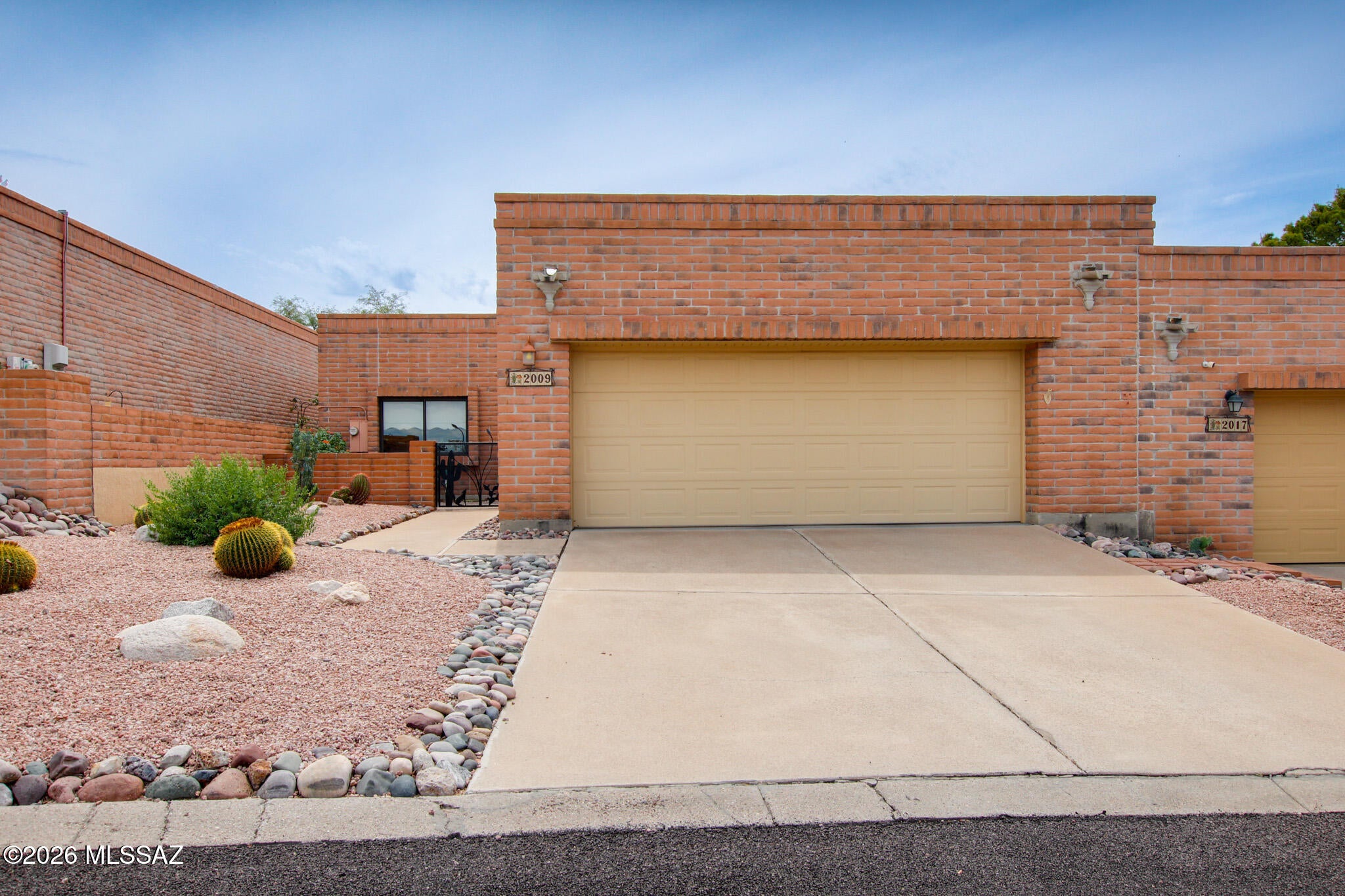 Single-level territorial-style TH in the highly sought-after La Cholla Hills subdivision. Ideally situated on a desirable north/south-facing lot, this 2-bedroom, 2-bath home offers approximately 1,650 sq. ft. of comfortable living space with a bright, open-concept layout. Step through the private wrought-iron gate into a welcoming living and dining area designed for easy everyday living and entertaining. The territorial-style architecture adds timeless character while the single-level floor plan provides convenience and functionality. Located in La Cholla Hills, this home offers a wonderful opportunity for buyers seeking a spacious townhome in an established and desirable community. Whether you're looking for a full-time residence, winter retreat, or low-maintenance home.