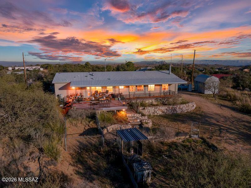 Fantastic 1.25-Acre Horse property in the Heart of Oracle, AZ. Welcome home to this private & versatile property offering stunning mountain views & space to live, work, & play. This charming 3-bedroom, 2-bath home features a desirable split-bedroom floor plan & fresh interior paint for a warm, welcoming feel. Recent upgrades include a brand-new metal roof plus newer heating & cooling systems for comfort & efficiency. The spacious great room flows into a bright living area with built-in cabinetry & a cozy gas fireplace—perfect for cool Arizona evenings. The kitchen is both functional & inviting, featuring a breakfast bar, brand-new appliances, & a dedicated dining area.
Step outside to an impressive back deck ideal for entertaining or relaxing complete with low-maintenance Trex decking. The front yard showcases beautiful rock work, an outdoor kitchen & grill area, plus rose bushes that bloom beautifully. A standout feature is the separate 1-year-old studio with power, metal roof, & its own viewing deckperfect for hobbies, a home business, or creative space. Additional features include a storage shed, dog run or chicken coop, & a metal Conex box. Private, spacious, & full of possibilitiesthis Oracle retreat is a must-see.