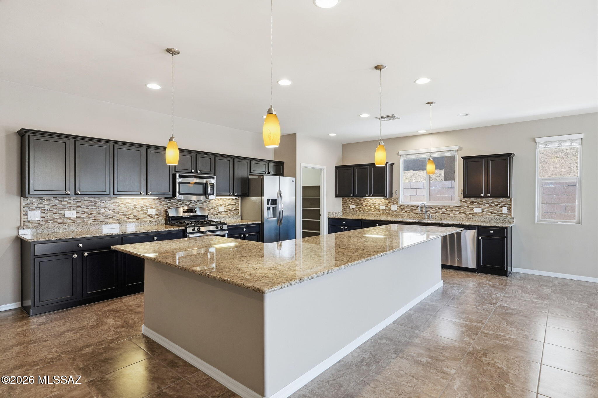 Priced to sell!!  This highly sought-after Timothy model, by Richmond America, offers 2,302 sq ft of thoughtfully designed living with 3 bedrooms, 2 baths, and a flexible den. The open-concept great room flows seamlessly into a spacious kitchen featuring an oversized granite island, abundant cabinetry, walk-in pantry, and ample prep space--perfect for entertaining. The floor plan provides privacy, while expansive windows fill the home with natural light. Enjoy a private covered patio with stunning mountain views. Complete with a dedicated laundry room and located in desirable Eagle Crest Ranch, this home blends comfort, style, and functionality.