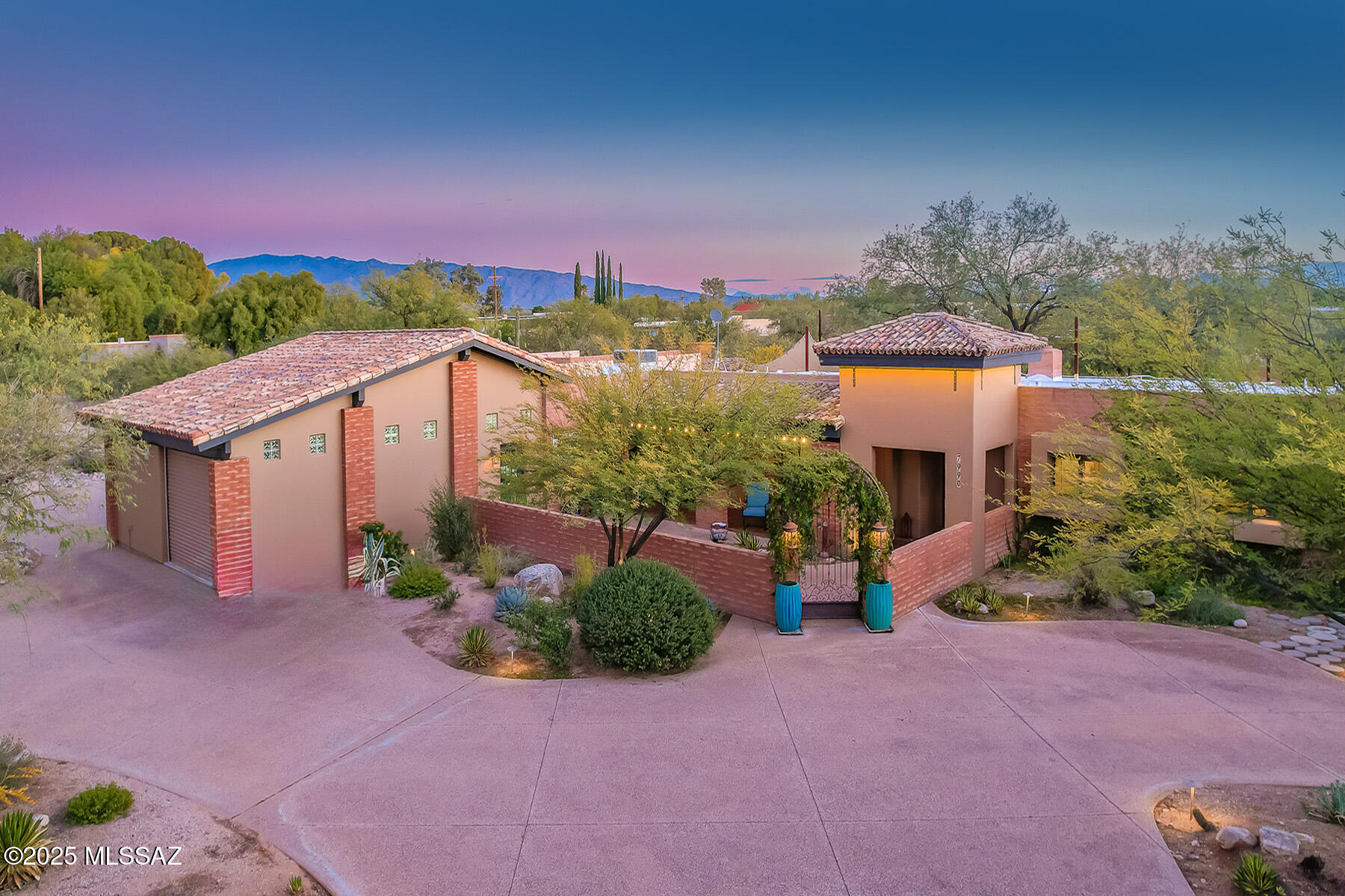 Beautifully modernized Desert Oasis! 
A beautiful arched gated entry welcomes you into the courtyard of this exceptional home.  Featuring 4 Bedrooms /4 baths w/den-office.  
Car collectors & hobbyists will appreciate the 7 car parking capacity across two garages; Offering convenience & security.

An inviting floor plan includes a sunken living room, raised media/sitting area & a dining area located off kitchen w/dramatic fireplace.

Gourmet kitchen is an entertainer's dream, showcasing a huge island, SS appliances, beautiful cabinetry & a large walk-in pantry. 
Foyer to spacious primary suite w/built in upper cabinet w/dresser, beautiful decorative metal doors to front patio. Primary bathroom features walk-in shower, soaking tub 2 sink vanity walk-in closet & linen closet. Spacious 2nd/3rd bedrooms, 4th bedroom is a guest suite w/closets, private bath & back patio access. Laundry room features cabinets & outside access.  Abundant storage throughout the home. 
Step outside to a backyard designed for relaxation & entertainment.
Situated on a 0.9 acre lot, nearly fully enclosed by a block wall, the outdoor space features a BBQ w/island-bar, sparkling pool & spa, covered patio with extended open patio, well placed trees that create an atmosphere of privacy & comfort.  A separate pool house/studio (205 SF) offers a private, versatile work/play space. 
A rare opportunity, this home blends modern comfort, exceptional privacy, ample space and resort style amenities to create a retreat for the most discerning buyer.  An absolute must see.
