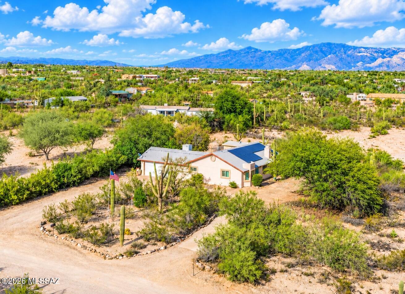 Embrace the Tucson lifestyle in this charming one-story Southwest home situated on a spacious 1-acre lot! Offering 1,659 sq. ft., 3 bedrooms and 2 full baths, this bright custom model blends comfort with plenty of room to enjoy Arizona living, including a fireplace in the living room.  A horseshoe driveway welcomes you home, while a 2 car attached garage provides convenient parking and storage. Need more space? You'll love the detached workshop, storage shed and ramada - perfect for RV or additional vehicle parking. Solar adds energy efficiency, and with no HOA, you'll have the freedom to make this wonderful desert property your own. Enjoy wide-open space, sunshine and the relaxed Southwest lifestyle! New roof 2024, New A/C 2023. Seller to pay pay off solar with acceptable offer.