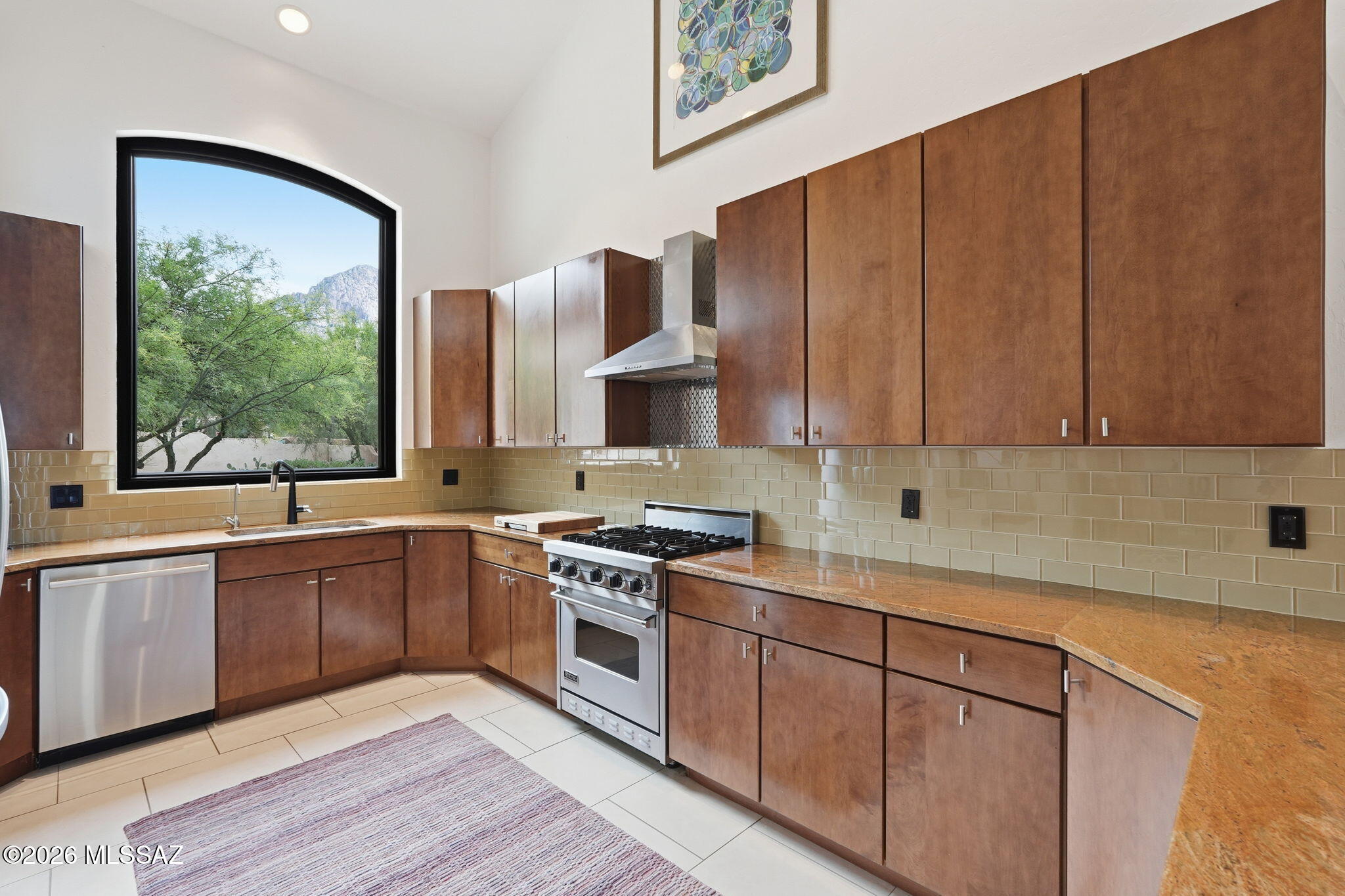 Welcome to your private desert sanctuary in the exclusive guard gated community of La Reserve! Perfectly positioned against the rugged, majestic backdrop of Pusch Ridge, this meticulously maintained 3BD/2BA (2,595 sqft) residence offers the ultimate blend of sophisticated living and the raw, natural beauty of the Sonoran Desert. Step inside to a light-filled interior where soaring ceilings and large picture windows bring the outdoors in. This home features all brand-new energy efficient windows from Renewal by Anderson, totaling $40k. The expansive floor plan is designed for both grand entertaining and quiet comfort, featuring a welcoming Great Room. The gourmet kitchen is a chef's delight, boasting ample cabinetry and a thoughtful layout that flows effortlessly into the casual dining and