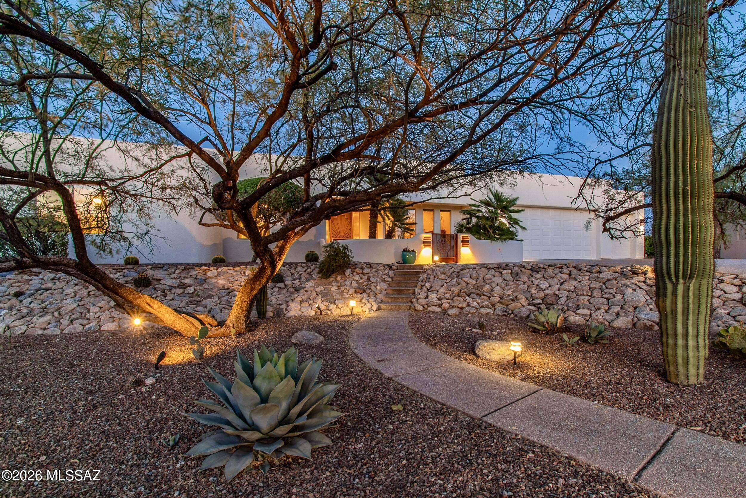 Set within the coveted northeast area of Winchester Ranch in Tucson, this exceptional desert residence captures the essence of refined Arizona living. Situated on a private lot with thoughtful northeast positioning for year-round outdoor living and energy efficiency, the property offers breathtaking panoramic views of the Santa Catalina Mountains, including iconic Thimble Peak, and the Rincon Mountains. The home's striking curb appeal is undeniable, enhanced by a canopy of scaffolding mesquites, fresh exterior paint, aggregate concrete walkways and driveway, and a fully enclosed front courtyard for observing stunning sunset views. Designed for seamless indoor-outdoor living, five separate walk-outs invite you to experience the resort-style living and multiple outdoor entertaining spaces. The back yard features a Pebble Tec pool with a lagoon, built-in bench, KoolCote decking, and a premium self-cleaning Baja Spa set within flagstone. Entertain effortlessly with a built-in gas BBQ, fire pit, extended built-in seating, and integrated patio speakers, all surrounded by mature, lush landscaping, serene desert beauty, and uninterrupted mountain views.

Inside, soaring 12-foot ceilings and expansive windows fill the home with natural light while showcasing the surrounding landscape. Architectural details such as curved walls, custom built-ins, and window seating create a warm yet sophisticated ambiance. The great room features a gas fireplace and flows seamlessly into the kitchen while maintaining a graceful separation from the formal dining space.

The kitchen is both functional and inspiring, offering stunning mountain views from the dining nook and prep areas. Outfitted with a Sub-Zero refrigerator, Dacor double ovens with convection, a new KitchenAid 5-burner gas range, Bosch dishwasher, and extensive cabinetry, including a walk-in pantry, coffee bar, and built-in desk for organization or as additional entertainment space.

A split-bedroom floor plan ensures privacy and flexibility, ideal for guests or multi-generational living. The primary suite is a tranquil retreat with direct backyard access, concrete flooring, and a luxurious 5-piece ensuite bath featuring dual vanities, a soaking tub with serene mountain views, a walk-in shower, and a spacious walk-in closet.

Exceptional functionality extends to the third 4-piece bathroom, which features an atrium patio door to the patio, ideal for entertaining outdoors or on fun-filled pool days. A spacious laundry room offers abundant storage, a craft desk, a built-in ironing board, and a secondary refrigerator. The oversized and extended-length 3-car garage features new insulated overhead doors with an 8' header height, updated belt-driven openers, a dedicated workshop, built-in cabinetry, additional storage, and a convenient service door.

Additional conveniences include: a new dual-zoned HVAC system in 2021, water softener, filtration, and reverse osmosis systems, new remote-controlled blinds in 2023, built-in speakers in living areas, and tile flooring in all high-traffic areas. Peace of mind continues outdoors with a new irrigation system, updated landscape lighting, new turf installed in 2020, and meticulously maintained grounds for optimal watershed management.

Original plans for this Tara Sun Custom Home Builders 1999 residence are available for review, featuring 2x6 construction and other high-quality materials.

This is a welcome opportunity to own a private, exceptionally well-built, view-oriented home that seamlessly blends luxury, functionality, and the natural beauty of the Sonoran Desert.