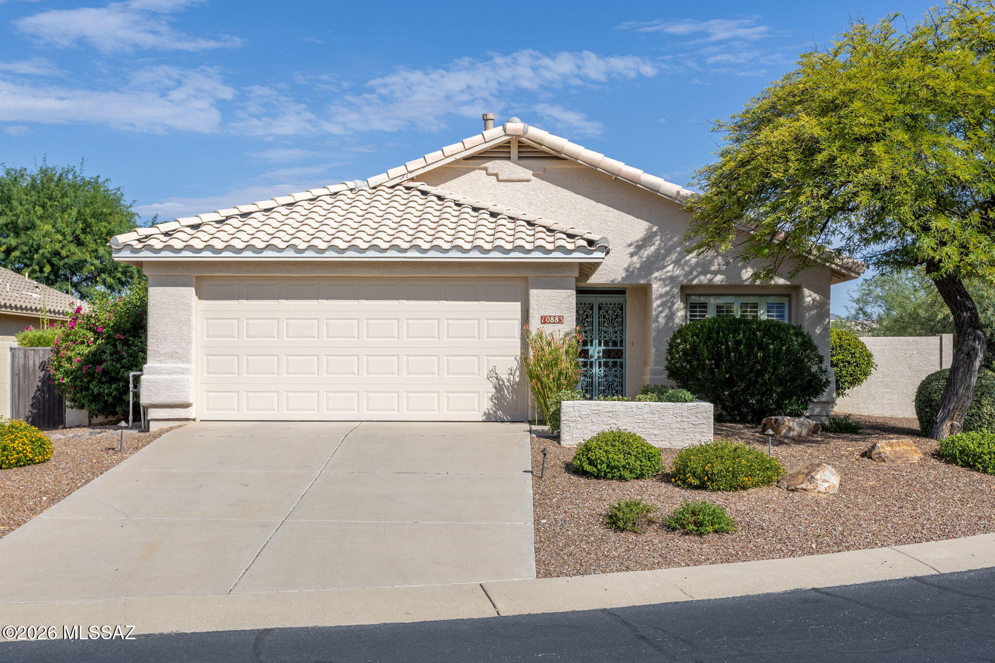 Welcome to this charming 3 bedroom, 2 bath home nestled in the heart of Oro Valley. Thoughtfully designed with a desirable split bedroom floor plan, this home offers privacy and functionality, perfect for families, guests, or working from home. The spacious living areas create a comfortable setting for everyday living and entertaining, while the well-appointed kitchen flows seamlessly into the heart of the home. The private primary suite offers a relaxing retreat, separated from the secondary bedrooms for added peace and quiet. Venture to the backyard through the Arizona room to splish & splash in the sparkling pool or settle under the covered pergola to enjoy those stunning AZ sunsets. This home features a brand new roof and water heater, & EV Charger! Conveniently located near top-rated schools, parks, shopping, dining, and everything Oro Valley has to offer. This home blends comfort, convenience, and the sought-after lifestyle that makes this community so desirable.