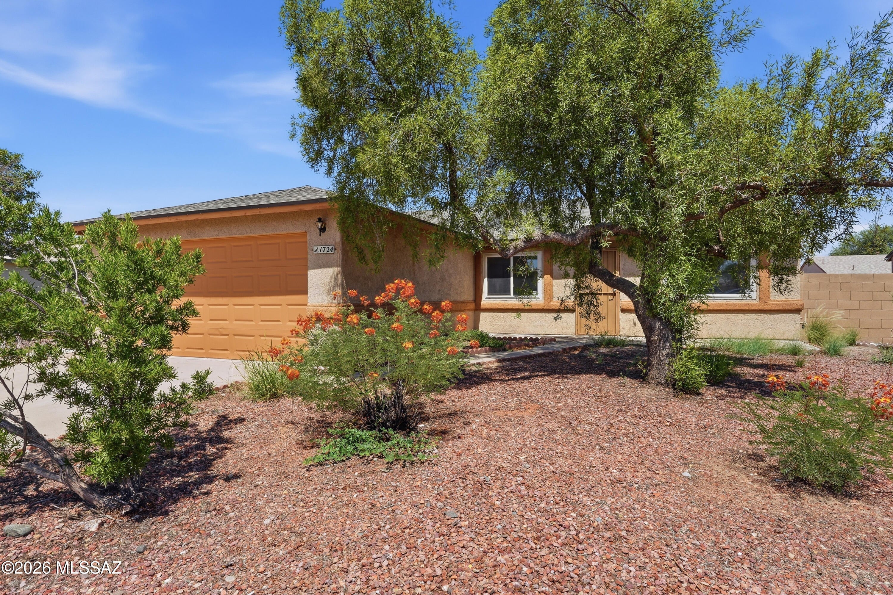 Beautifully updated 4-bedroom home in the Greens at Midvale Park offering 1,681 sq ft of fresh, modern living. This remodeled gem features spacious living and family rooms, high ceilings, granite kitchen countertops, stainless steel appliances, and stylish vinyl flooring. The primary suite includes a walk-in closet and upgraded shower. Enjoy a covered patio, low-maintenance landscaping, and a fully fenced yard. With a 2-car garage, newer finishes, and a convenient Southwest Tucson location near shopping and I-19, this move-in-ready home delivers comfort, style, and value.
