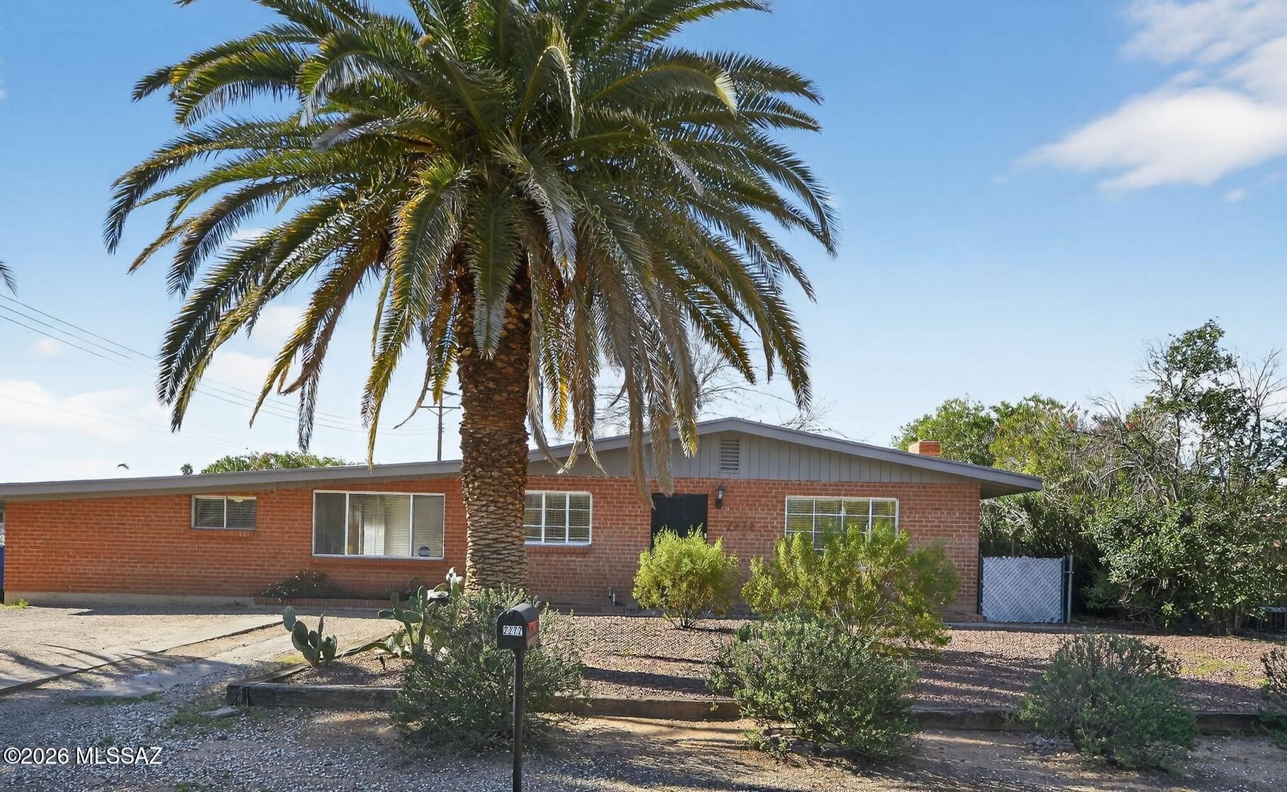 This tastefully updated 5-bed, 2-bath home offers a cozy living space and timeless character.   Inside, you'll find an inviting layout that is both stylish and easy to maintain- featuring tile flooring throughout, exposed wood beam ceilings that add warmth, living areas perfect for relaxing or entertaining, spacious bedrooms, and updated bathrooms.  Step outside to a backyard designed for enjoyment, complete with a pool and spa--ideal for cooling off on hot days or hosting guests. The large corner lot offers additional space for outdoor living, gardening, or customization to suit your needs. Centrally located, you're never far from anything Tucson has to offer.  Don't miss this opportunity to own a versatile home with character, space, and desirable outdoor amenities.