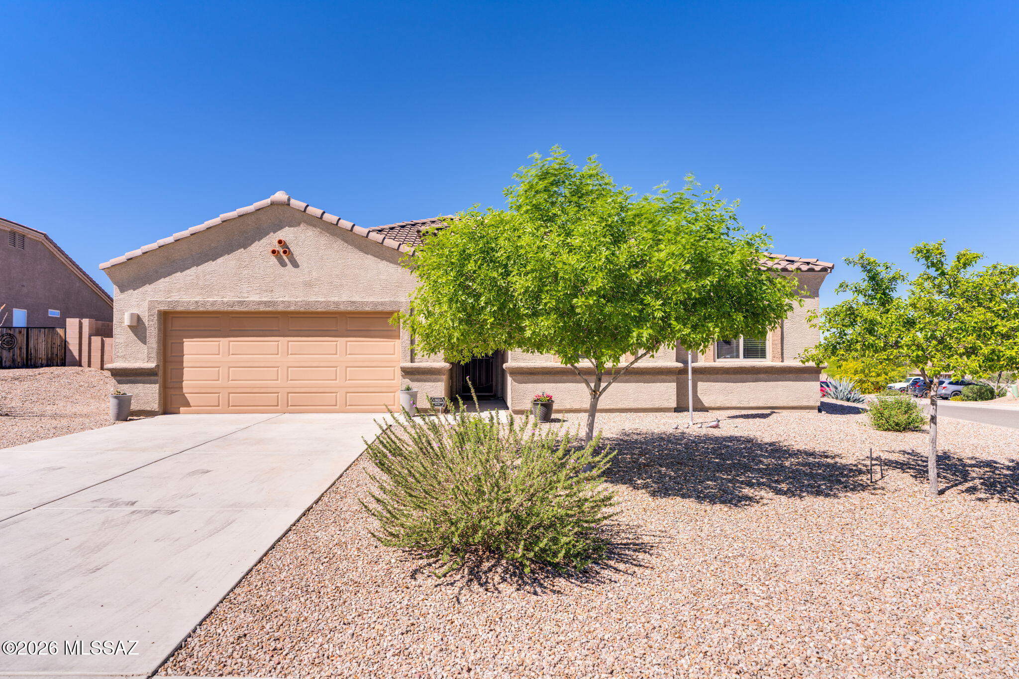 Welcome home to this well-maintained 3 bed, 2 bath home with 1,583 sq ft on a corner lot in the Sycamore Vista neighborhood within the Vail School District. This energy-efficient home features double pane windows and a security screen door. The open living area connects to the kitchen with a kitchen island, granite countertops, stainless steel appliances, a walk-in pantry, and breakfast bar seating. The dining area sits just off the kitchen and has lots of natural light. The primary suite includes a double vanity, walk-in shower, and two closets. A split floor plan places the additional bedrooms near the hall bathroom and laundry room. The landscaped backyard includes a covered patio, extended paver patio, large pergola, and storage shed and RV gate on the sideyard.