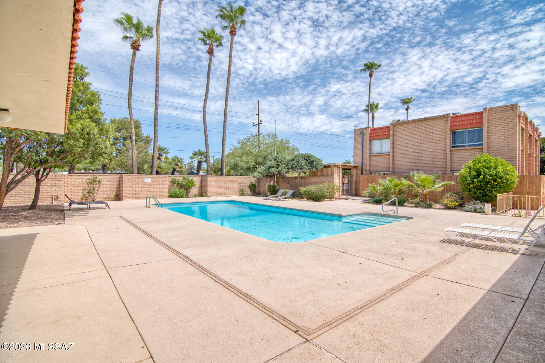 Move-in ready 2BR/2BA two-story townhouse in a prime central Tucson location! This updated home features fresh interior paint, new carpet, refreshed kitchen and bath cabinetry, updated bathroom fixtures, newer A/C and water heater, and a bright open floor plan with a breakfast bar. Enjoy seamless indoor-outdoor living with a private fenced patio, spacious bedrooms, washer/dryer, and a covered carport. HOA covers water, sewer, trash, roof, exterior building maintenance, exterior paint, and community pool access for easy, low-maintenance living. Rentals permitted! Minutes from the University of Arizona, Banner, downtown, shopping, dining, and entertainment.