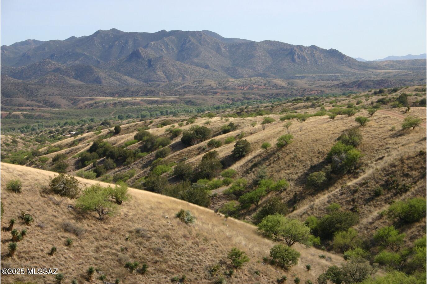 Great Views of Red Mountain, Santa Ritas Mountains and Patagonia below. The property is perfect for off grid living, rolling terrain for privacy, no HOA, attractive CC & R's, a good area for wells, electric is available at the lot line of parcel 2 or the entire 35+ acres. Lush vegetation, canyons and hilltops. Fence is not any property lines. Abundant wildlife close to National Forest. Close to Town of Patagonia yet private and rural.