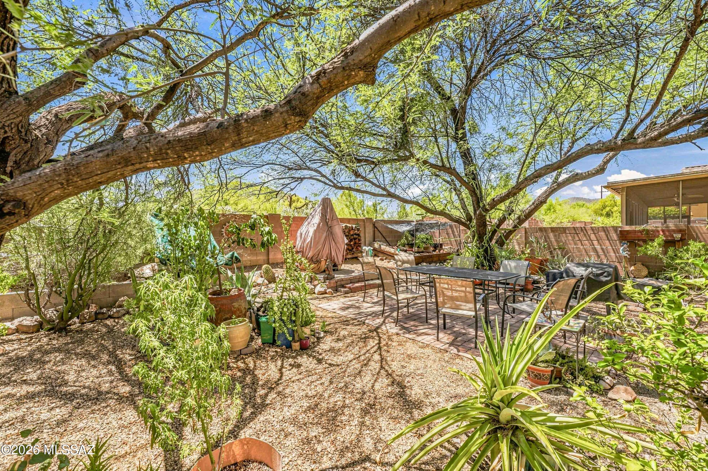 SMART UPGRADES MEET THE WEST TUCSON LIFESTYLE! This versatile 3 bedroom, 2.5 bath home with a den and 3 car tandem garage delivers the space today's lifestyle demands, whether you're working from home, entertaining friends, staying active, or simply looking for room to spread out. High value updates add comfort and peace of mind including dual HVAC systems approximately 8 years old, tile roof underlayment replaced just 3 years ago, a Navien natural-gas tankless water heater with EcoFlow technology, and a convenient 240V EV outlet in the garage. Plus, enjoy the added benefit of a low HOA, only $20 per month! The main level offers beautiful tile flooring throughout and plenty of room to gather, with separate living and dining spaces plus an inviting family room that flows into the kitchen. Granite countertops, stainless-steel appliances, a solar tube for added natural light, and a casual breakfast nook create a comfortable everyday hub. The flexible den is ready to become your home office, gaming room or workout space. A convenient powder room on the main level provides extra functionality. Upstairs, bamboo flooring adds a fresh, modern feel. The expansive primary suite has its own bonus space, perfect for a reading lounge, yoga area, or quiet retreat, plus a remodeled ensuite bath with a tile walk-in shower. Two additional bedrooms and a guest bath complete the second level.The backyard offers extra privacy with no direct rear neighbor and plenty of established vegetation that creates a lush, inviting outdoor setting. Relax under the covered porch, fire up the natural-gas BBQ for easy entertaining, or take advantage of the greenery and outdoor space to expand the existing garden and make it your own. An 865-gallon rainwater harvesting tank and gutters add a practical, eco-conscious touch. Enjoy fantastic energy savings with the efficient leased solar system at only $90 per month, with most months requiring just the connection fee to TEP. The location makes it easy to enjoy the best of the West Tucson lifestyle, with Starr Pass, Tucson Mountain Park, hiking and biking trails, golf, Pima Community College West Campus, shopping, dining, Downtown Tucson, and the University of Arizona all within convenient reach. With flexible living spaces, smart energy-conscious upgrades, inviting outdoor living, this home brings together comfort, convenience, and location. Ring doorbell and exterior cameras are not conveyed with property.