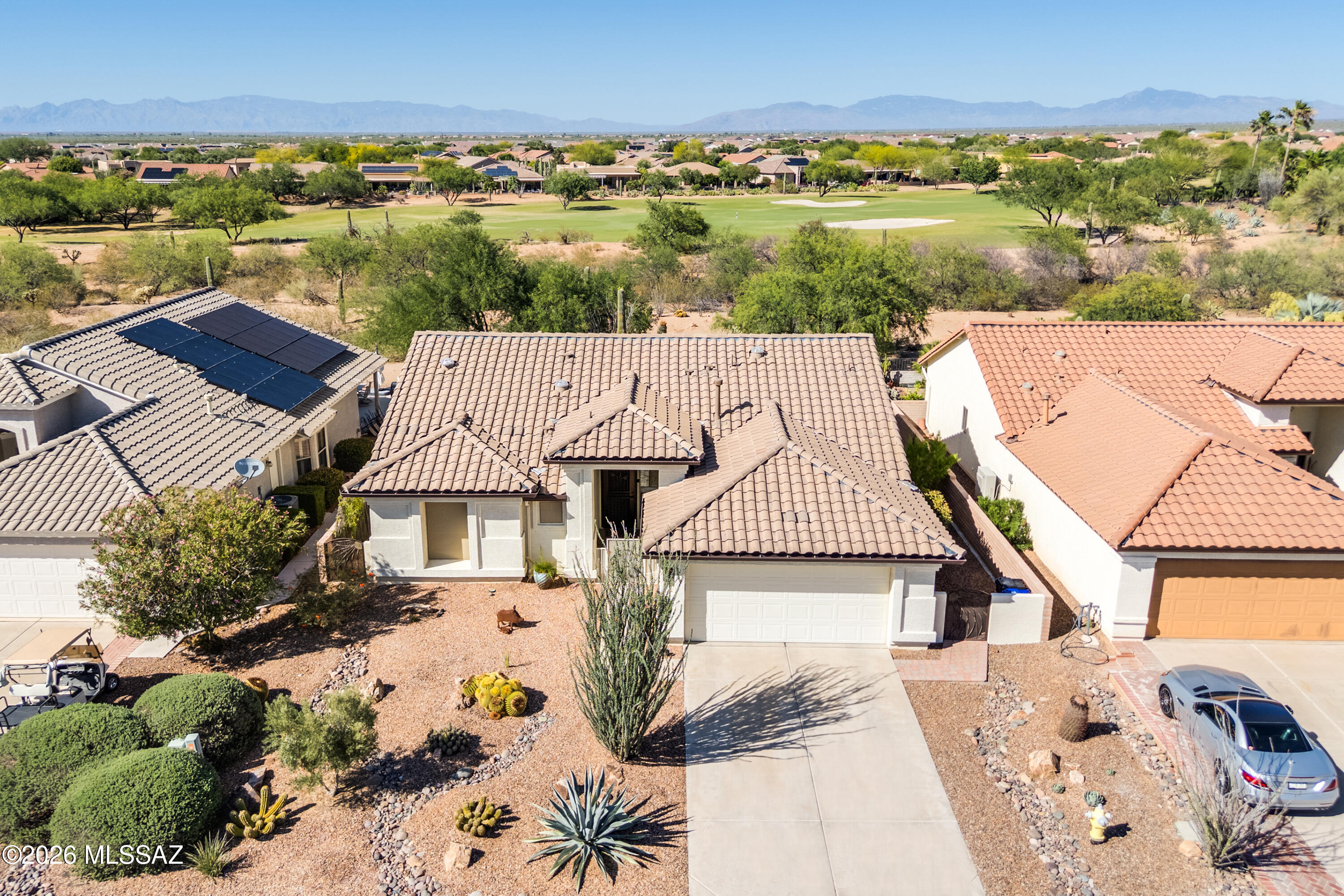 Situated on a spectacular desert homesite with golf course views beyond, this expanded Augusta model showcases stunning curb appeal with mature desert landscaping. Offering 1,552 sq.ft., 2 BR, 2 BA, plus a versatile den, the home also boasts more than $80,000 in improvements completed in recent years. The thoughtfully expanded floorplan adds 2' to both bedrooms and the den, creating enhanced living space and comfort throughout. Inside, you'll find all-tile flooring and an updated kitchen featuring granite countertops and new GE Profile stainless appliances (2025), including an induction range, three-door refrigerator with dual automatic ice makers, and a convection microwave with air fryer. The dining area is highlighted by a bright bay window that fills the space with natural light, while the spacious great room flows seamlessly to the outdoor living areas, ideal for enjoying Arizona's indoor-outdoor lifestyle. The owner's suite features direct patio access through a sliding glass door, a large walk-in closet with custom organizers, and an en suite bath with tile shower. The expanded guest bedroom offers added comfort for family and visitors, while the adjacent guest bath is conveniently located nearby. The den provides exceptional flexibility with a built-in wall bed, desk, and bookcase, making it ideal as a home office, guest space, or hobby room. Step outside to a large private backyard designed to capture the beauty of the surrounding desert landscape and fairway views beyond. Mature landscaping includes orange, lemon, and fig trees, creating a peaceful outdoor retreat. 
 
Major improvements since 2022 include a Lennox HVAC system with air filtration, new landscaping, backyard view wall, irrigation system, gutters, three solar tubes, solar screens, upgraded lighting, fans, window treatments, door and bath hardware, and more. Additional features include a roof replacement in 2019 with 13 O'Hagin vents, energy-efficient 2x6 construction with added insulation, and an extended-length garage.