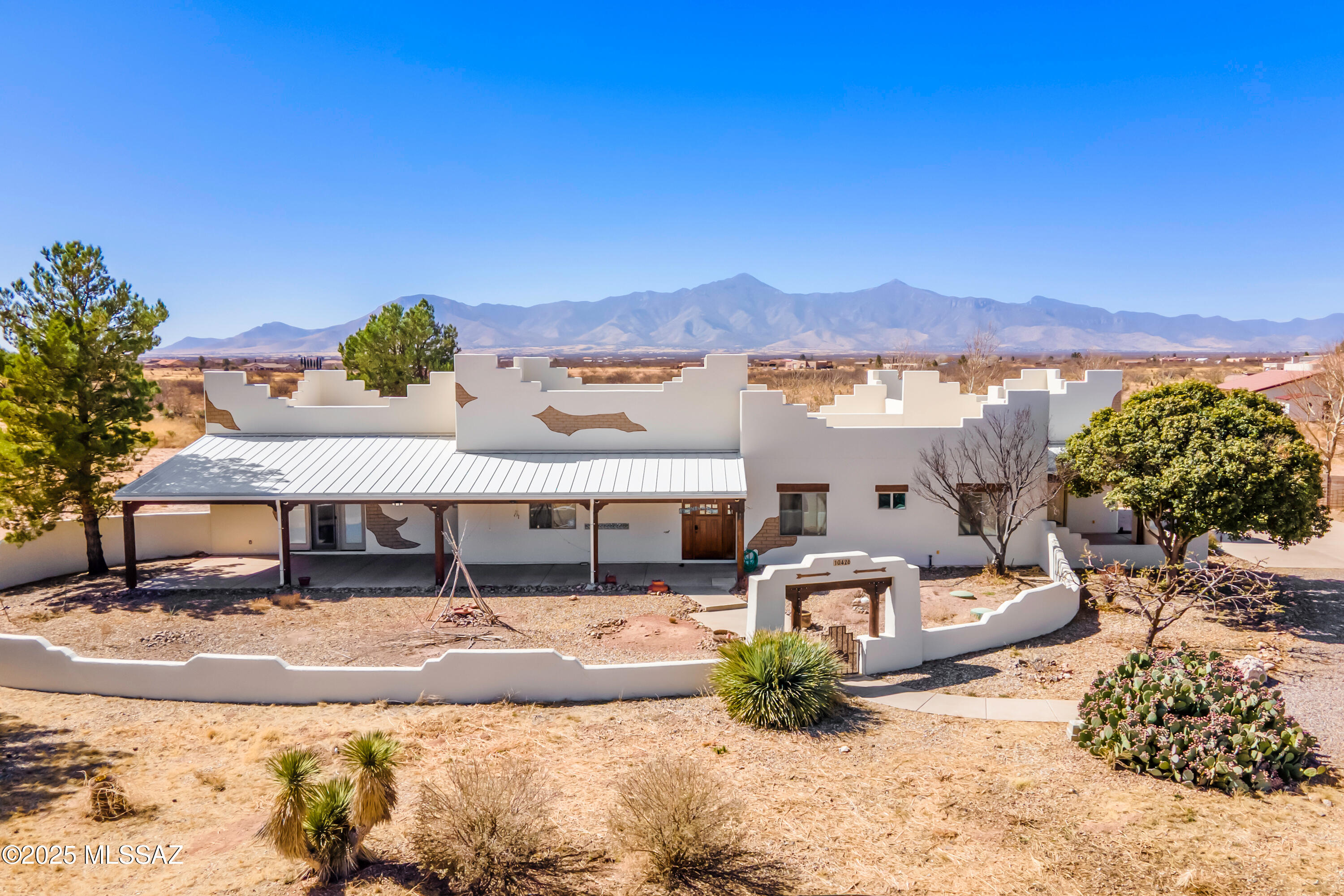 Spacious Santa Fe-Style Home with Dream Garage/Shop & Enclosed RV Parking on 4.89 Acres! Car lovers and adventurers-this property is for you! Nestled in a stunning high-desert setting at 4,200' elevation, this spacious Santa Fe-style home offers breathtaking mountain views, ample storage, and top-tier amenities for vehicles, hobbies, and self-sufficient living. The 3BR/3BA main house boasts an open-concept living area with a large kitchen featuring a natural stone island, custom cabinetry, a built-in bar with wine storage, and high-end appliances. The primary suite is expansive, with abundant natural light, a walk-in closet, and a luxurious en-suite bath with a jacuzzi tub, fireplace, and dual vanities. Two additional guest bedrooms offer built-in storage and walk-in closets. Continued... Other highlights include a home office nook, a generous laundry room with ample cabinetry, and multiple covered patios perfect for enjoying the serene surroundings and mountain views. For car enthusiasts, the separate garage/shop is a dream! It features four-car parking, a built-in office, a two-pole auto lift, 220v outlets, and a convenient half bathroom. Attached is a 45' x 20' RV garage with a 50amp plug and septic drain--all built for convenience! High ceilings, skylights, and LED lighting ensure functionality and comfort. Also a permitted 22KW Generac standby generator. Set on a scenic 4.89 acre lot, the property includes young fruit trees, mature peach trees, desert willows, and an extensive drip irrigation system. The raised garden beds produce a bounty of vegetables, grapes, and blackberries. Zoned for horses, livestock, and moreyour rural retreat awaits. Don't miss this amazing homestead!

Legal Description:
Barbary Estates Rep Of Survey Bk10 Pg36 Por Lot 6 By M&B Beg At N E Cor Said Lot 6 Thn S0deg E667.38' S89deg 57Min W319.15' N0deg W 667.38' N89deg 57Min E319.15' To Pob Sec 17-23-22 4.89Ac
