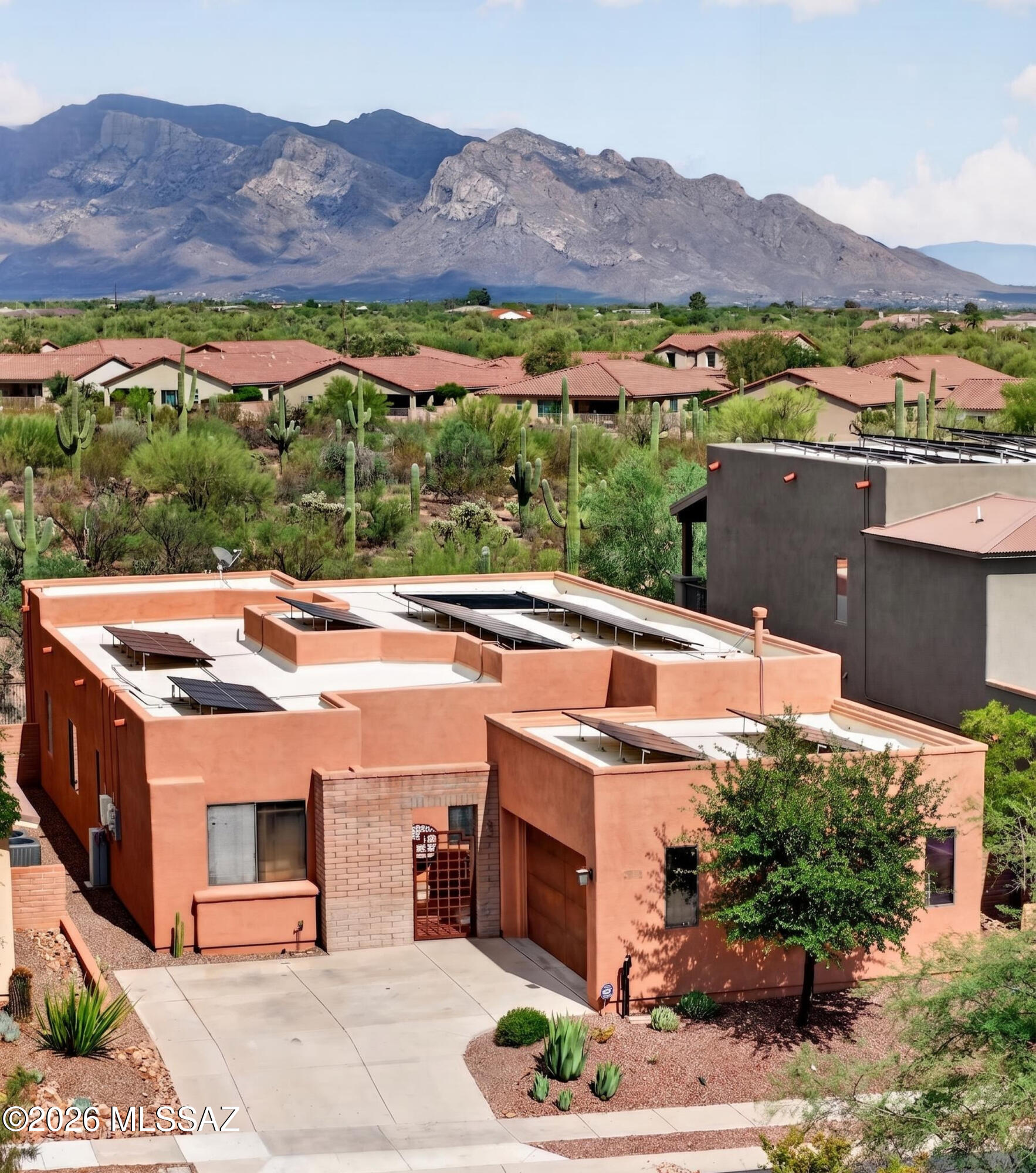 Stunning 3-bed, 2-bath + den contemporary home (2,503 sq ft) in the highly desirable gated SkyRanch community. Located on a private cul-de-sac backing to natural desert with no rear neighbors, this home offers unobstructed Catalina Mountain views. The open-concept great room features 15-foot ceilings, a fireplace, and surround sound. A gourmet kitchen boasts cherry cabinets, granite counters, and a large walk-in pantry. Relax in the private courtyard entry or the backyard oasis, complete with a solar-heated, self-cleaning PebbleTec pool and expansive covered patio. **Qualifies for Down Payment Assistance and/or rate buy down**