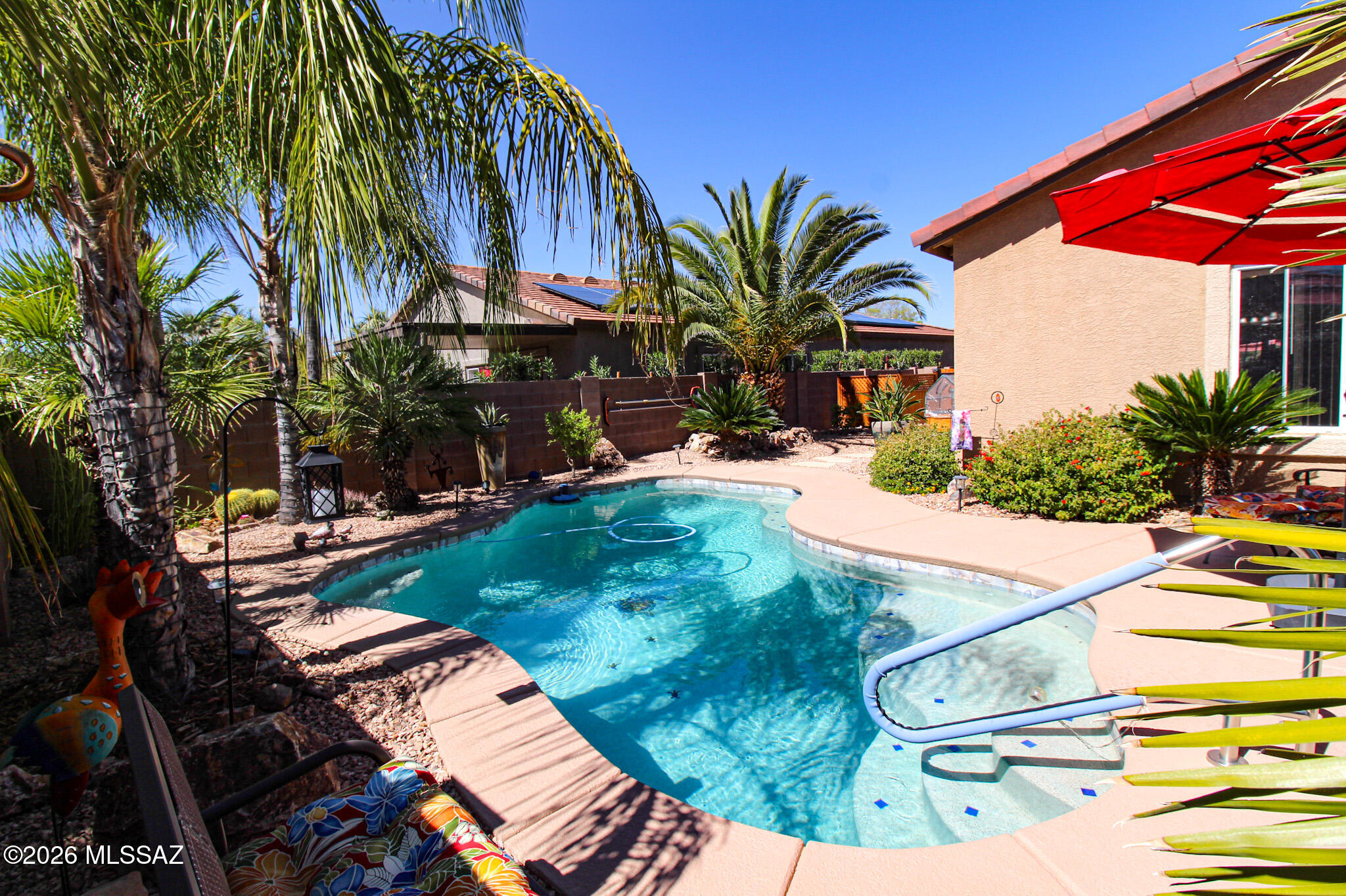 Catalina Mountain views, a sparkling free-form pool (replastered within the last 3 years complete with inlaid turtle tile). This is a classic Tucson retreat. The rear landscape includes mature palms, and a covered patio ideal for relaxing or entertaining under desert sunsets. Inside, you will find open living spaces showcasing a beautifully updated kitchen with granite countertops, an expanded island, custom cabinetry and updated lighting. You will also find a beverage bar and neutral tile flooring throughout the main areas. Bathrooms have been refreshed with updated vanities and vessel sinks in primary bath. Thoughtful improvements enhance both function and style. A soft water system, solar for energy efficiency, and low-care desert landscaping complete this warm and welcoming home.