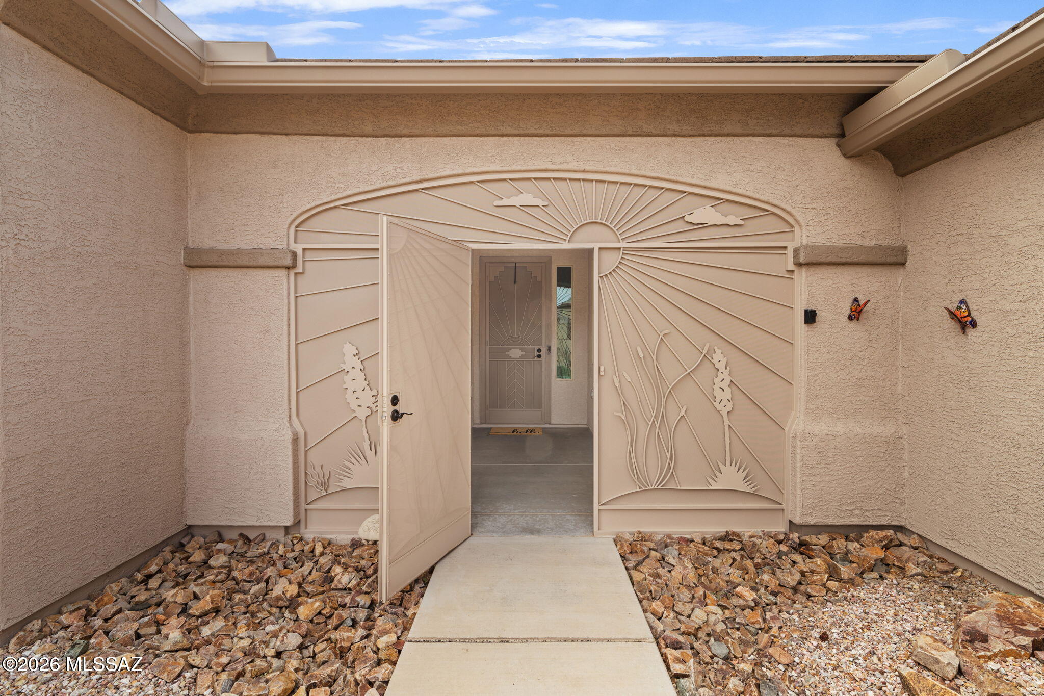 Beautifully maintained Green Valley home featuring 2 bedrooms, 2 baths, and a versatile den/flex space. The inviting open concept floor plan offers easy Arizona living with no carpet throughout. Enjoy year round indoor/outdoor living from the screened front and Arizona room, plus a charming backyard pergola perfect for relaxing or entertaining. Solar screens on all windows add shade and energy efficiency, while mature landscaping provides an established, welcoming setting. Features include a new HVAC installed in 2025, fresh exterior paint, owned reverse osmosis system, new front porch enclosure, over-height doors throughout, and an oversized 2.5-car garage with plenty of room for vehicles, golf cart, workshop, or storage. Move in ready and ready to enjoy!