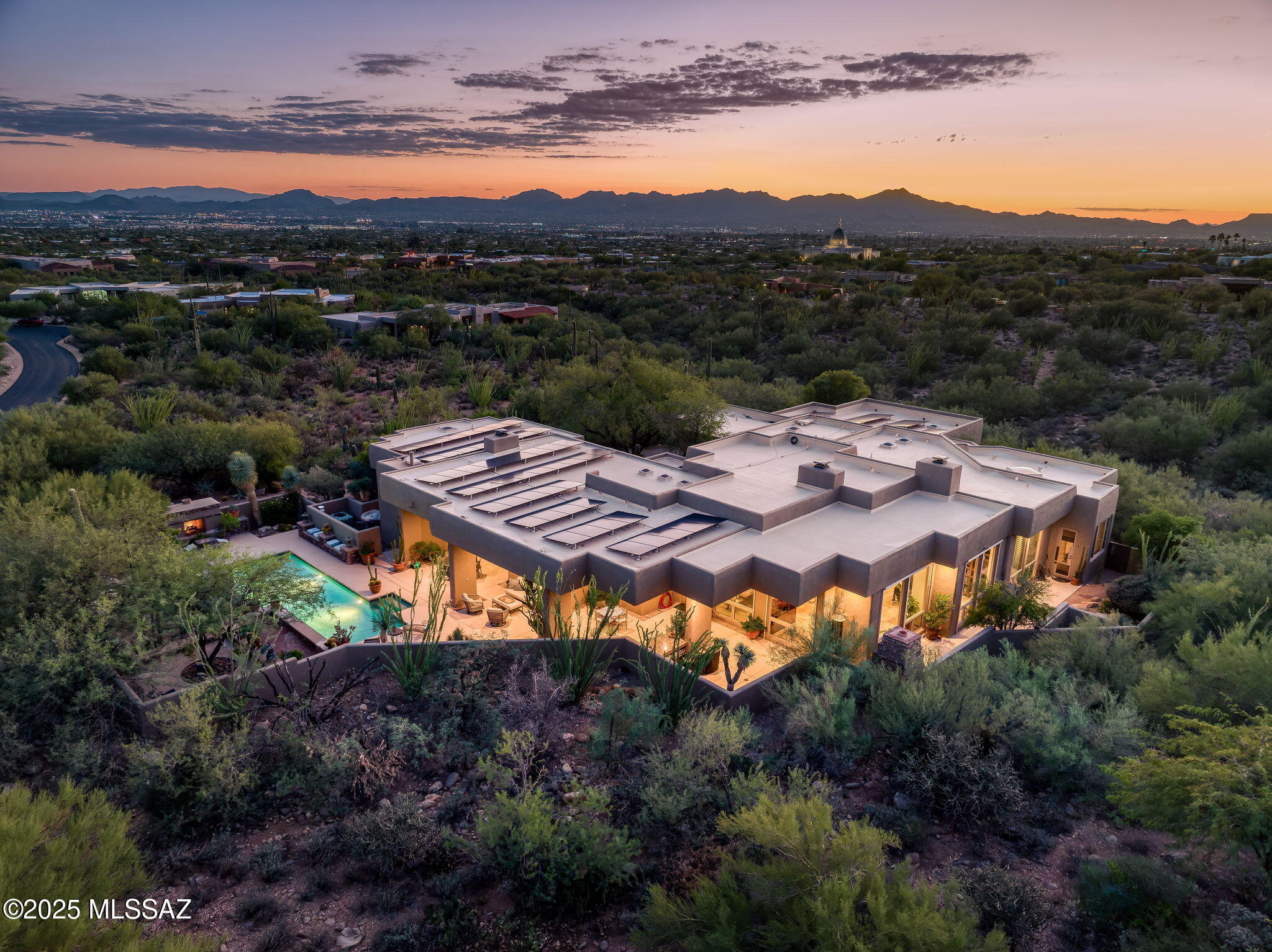 Splendid contemporary in exclusive gated Pima Canyon; 4 spacious bedrooms w/marvelous en-suite baths. Romantic primary retreat features a fireplace seating area & luxe spa-like bath. Open floorplan blends indoor/outdoor living, soaring ceilings, walls of glass frame sweeping Catalina Mtn views. Great room, Gourmet kit features 100 bottle Sub-Zero wine fridge, new Café 42'' refrigerator, 2 DWs, wet bar, new black leather-finish quartzite counters & back splash. New media rm w/ 86'' Sony screen, movie riser, 3 theater recliners, new AV system plus a home exercise studio. Resort-style1,000+ sqft patios, 2 outdoor FPs, pool/spa w/ water features, outdoor kitchen AND FULLY OWNED NEW 82-PANEL SOLAR = huge utility savings! Private, luxurious desert living near world-class golf, dining & shopping