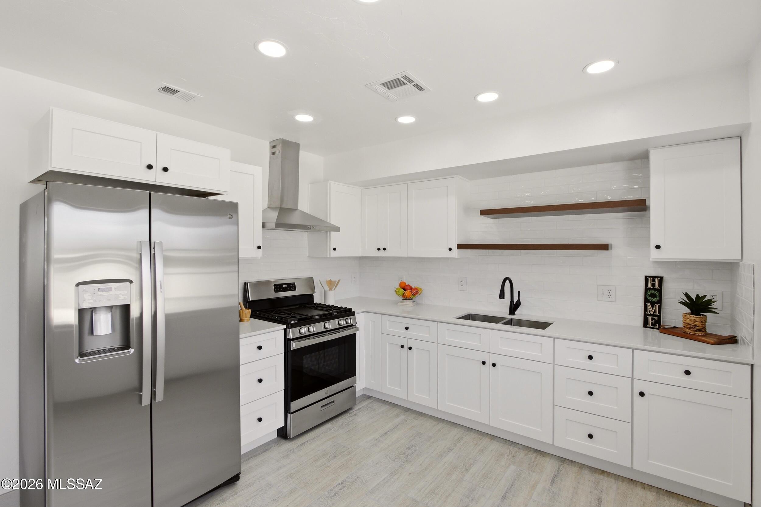 Beautifully renovated mid-town charmer.  Situated on almost 1/4 acre corner lot, this 3 bedroom/1 bath home is fully remodeled & move-in ready.  Tile throughout, gorgeous upgraded kitchen with new SS appliances & granite countertops. Stunning custom tile shower, new water heater & newer HVAC, attached garage with new overhead garage door.  This lot has access to parking in the back yard & plenty of room to build an ADU or casita.