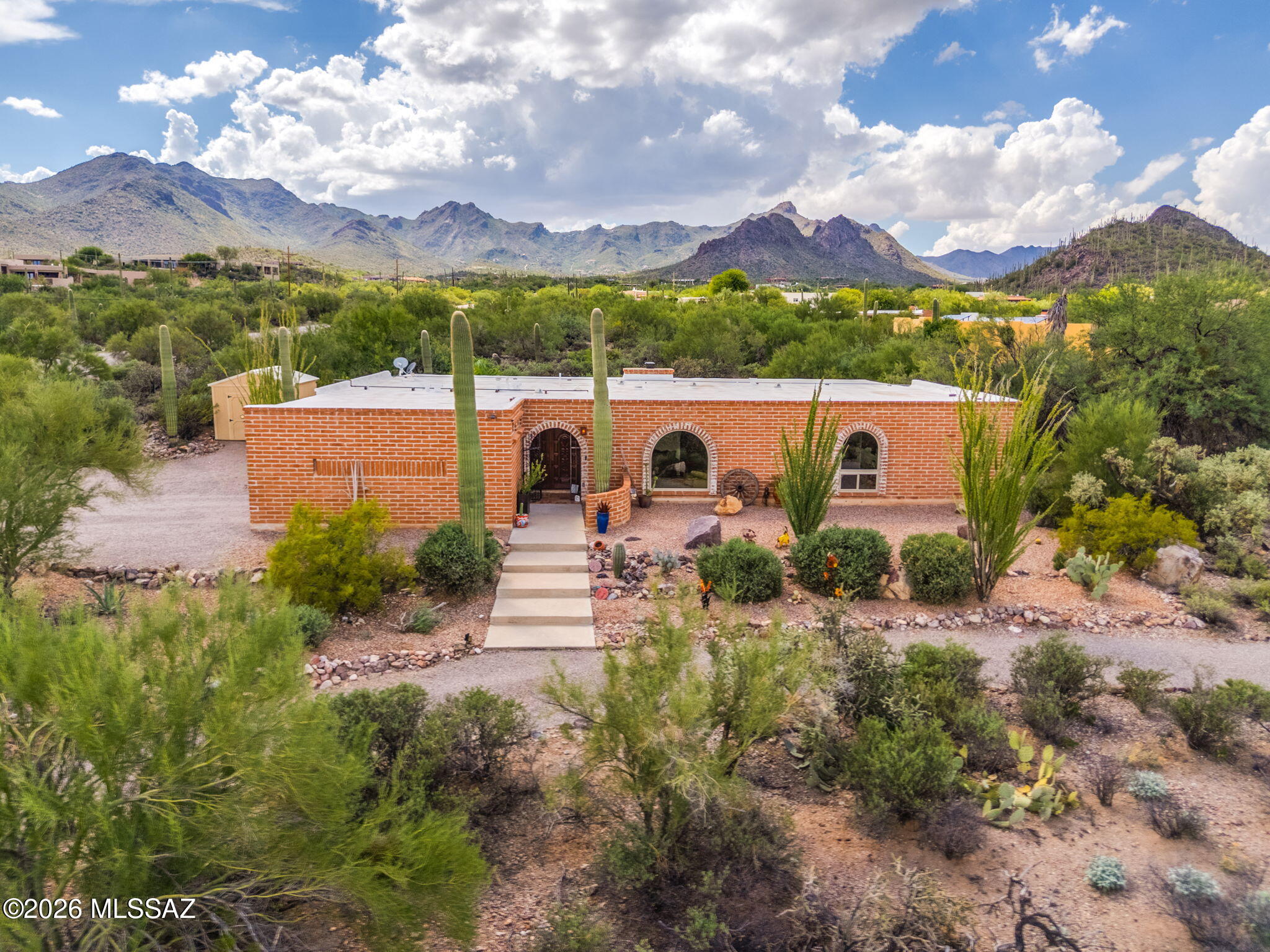 Beautifully updated 1973 burnt adobe Southwestern-style home situated on nearly an acre (.967) in Casas Colinas, offering sweeping mountain and city views, dark skies, and a wonderful sense of privacy. Thoughtfully renovated over the years, this distinctive home blends timeless Tucson character with modern comfort. The open, completely remodeled kitchen is complemented by updated bathrooms, Saltillo tile, newer carpeting in the bedrooms, new windows throughout--including sliding doors--fresh interior paint, updated fixtures, ceiling fans, and strategically placed solar tubes that bring natural light where it matters most. Outdoor living is equally inviting, featuring a newer Pebble Tec saltwater pool, low-maintenance artificial turf, mature palms and established landscaping, along with a reconfigured enclosed yard framed by block and corrugated-metal fencing. The two-car garage was substantially rebuilt in 2024 using burnt adobe brick to complement the architectural character of the home. Additional improvements include refreshed burnt adobe exterior finishes, roof-edge repairs, and a 10' x 12' storage shed.

With generous land, no HOA, and space that may accommodate an RV and/or future casita (subject to applicable zoning and approvals), this property offers a rare opportunity to enjoy privacy, views, and authentic Southwestern charm while remaining conveniently connected to Tucson.

Ideally located with easy access to Interstate 10, the University of Arizona, Banner-University Medical Center, downtown Tucson, the Arizona-Sonora Desert Museum, and major employers including Raytheon, Caterpillar, and Freeport-McMoRan. Restaurants, retail, and everyday conveniences are also within easy reach.